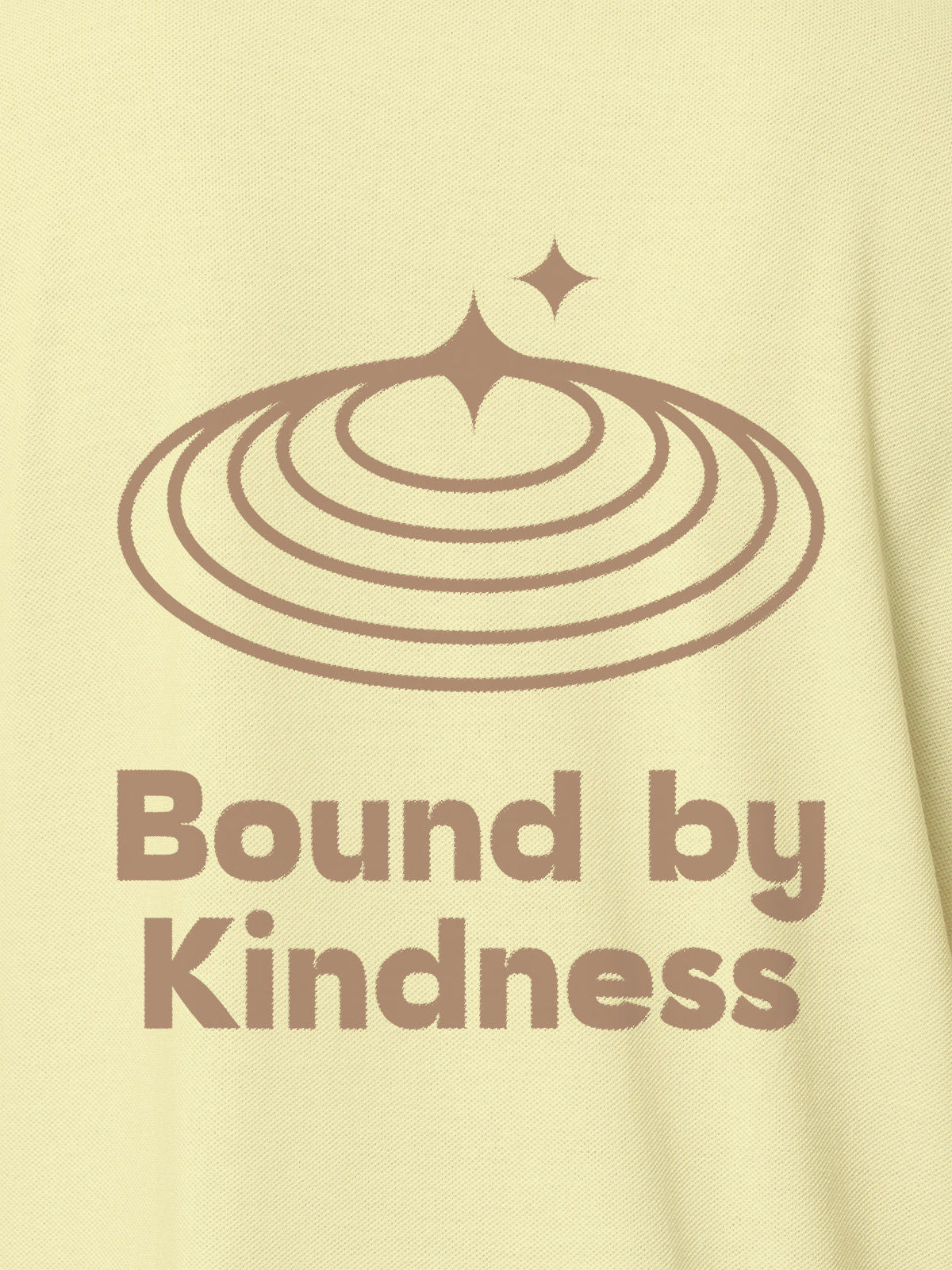 Close up of 'Bound By Kindness' design on Women's Yellow Polo T-shirt, highlighting intricate details and vibrant print.