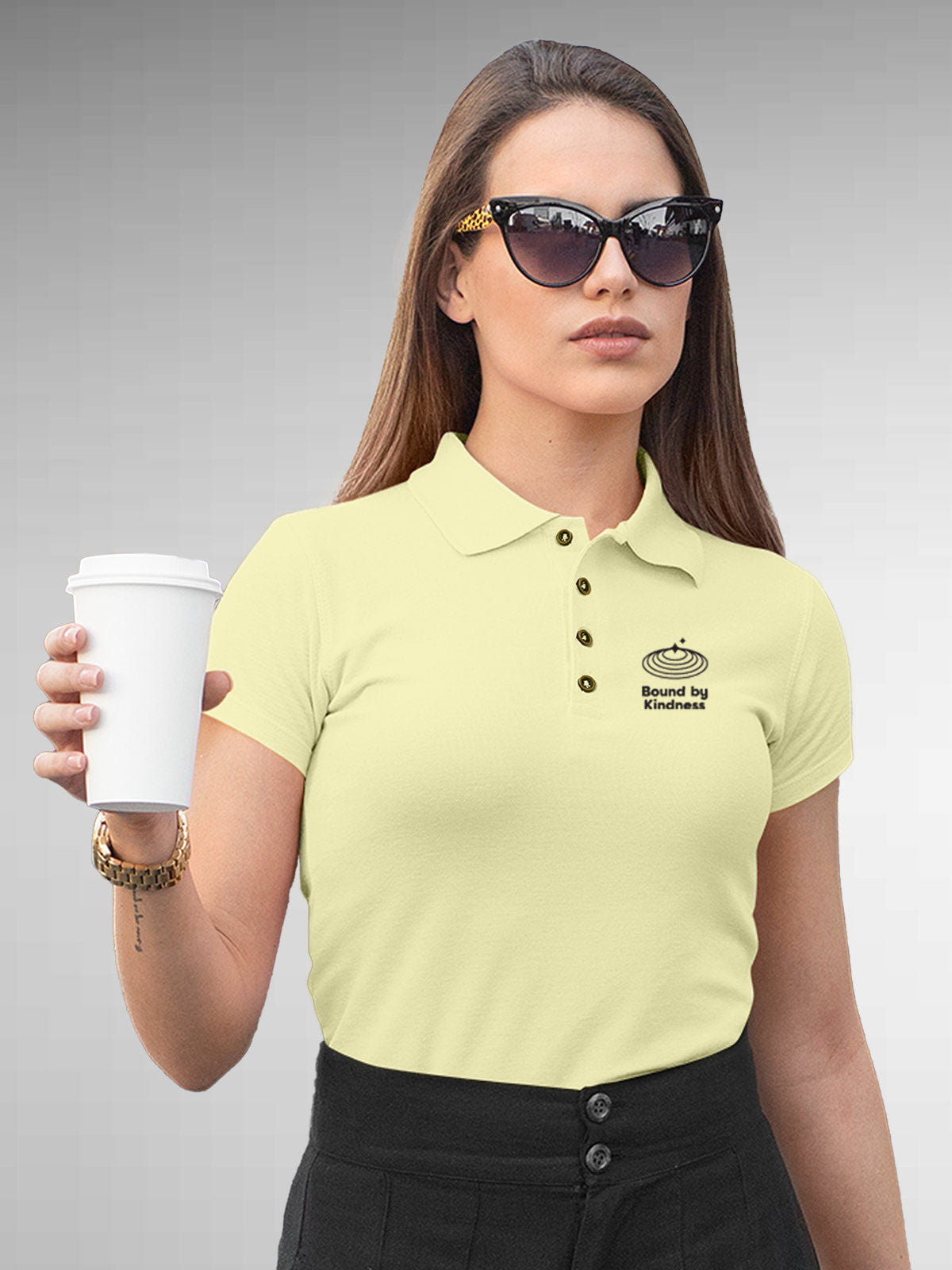 Model wearing Women's Yellow Polo T-shirt with 'Bound By Kindness' design, offering effortless style and premium comfort