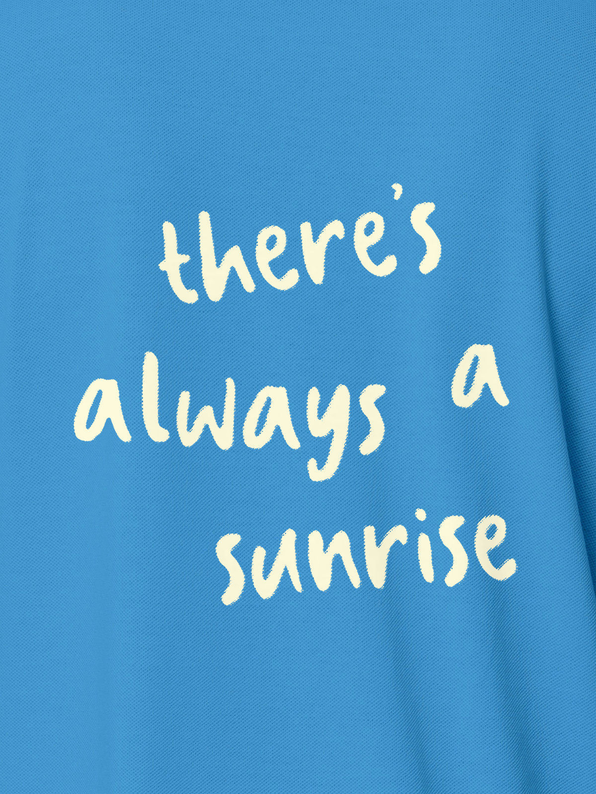 Close up of 'There's Always a Sunrise' design on Women's Blue Polo T-shirt, highlighting intricate details and vibrant print.