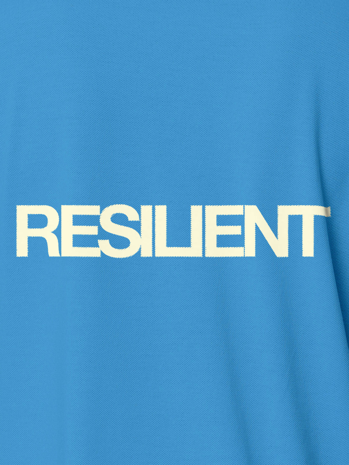 Close up of 'Resilient' design on Men's Blue Polo T-shirt, highlighting intricate details and vibrant print.