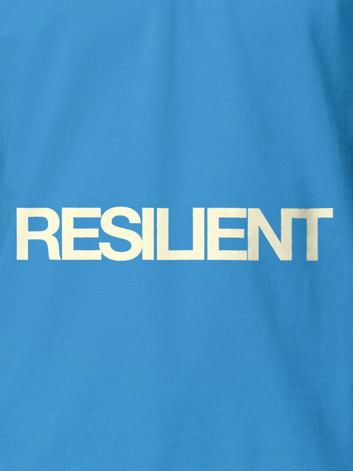 Close up of 'Resilient' design on Women's Blue Polo T-shirt, highlighting intricate details and vibrant print.