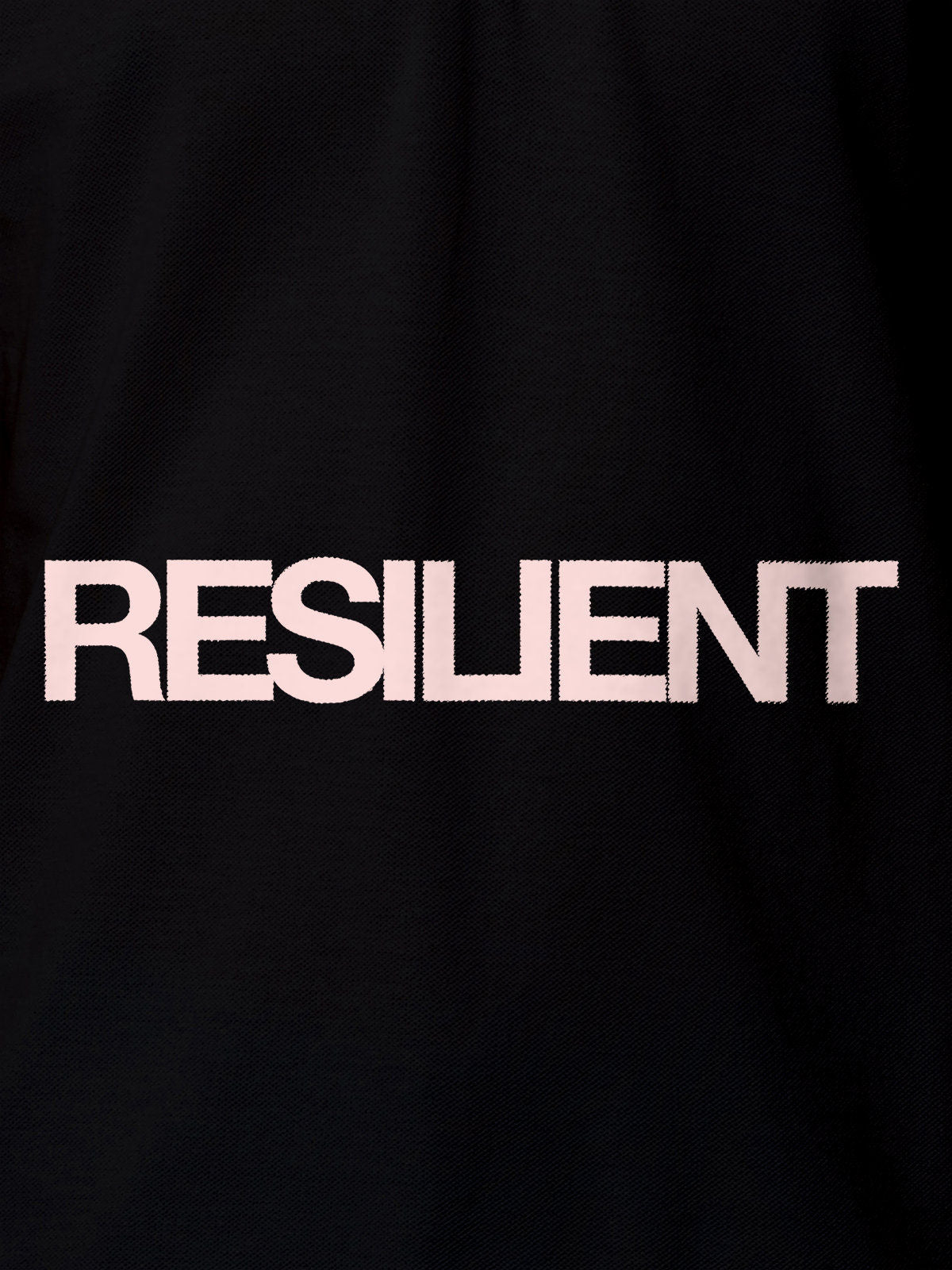 Close up of 'Resilient' design on Women's Black Polo T-shirt, highlighting intricate details and vibrant print.
