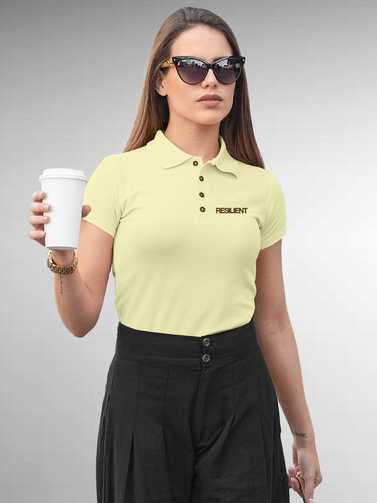 Model wearing Women's Yellow Polo T-shirt with 'Resilient' design, offering effortless style and premium comfort