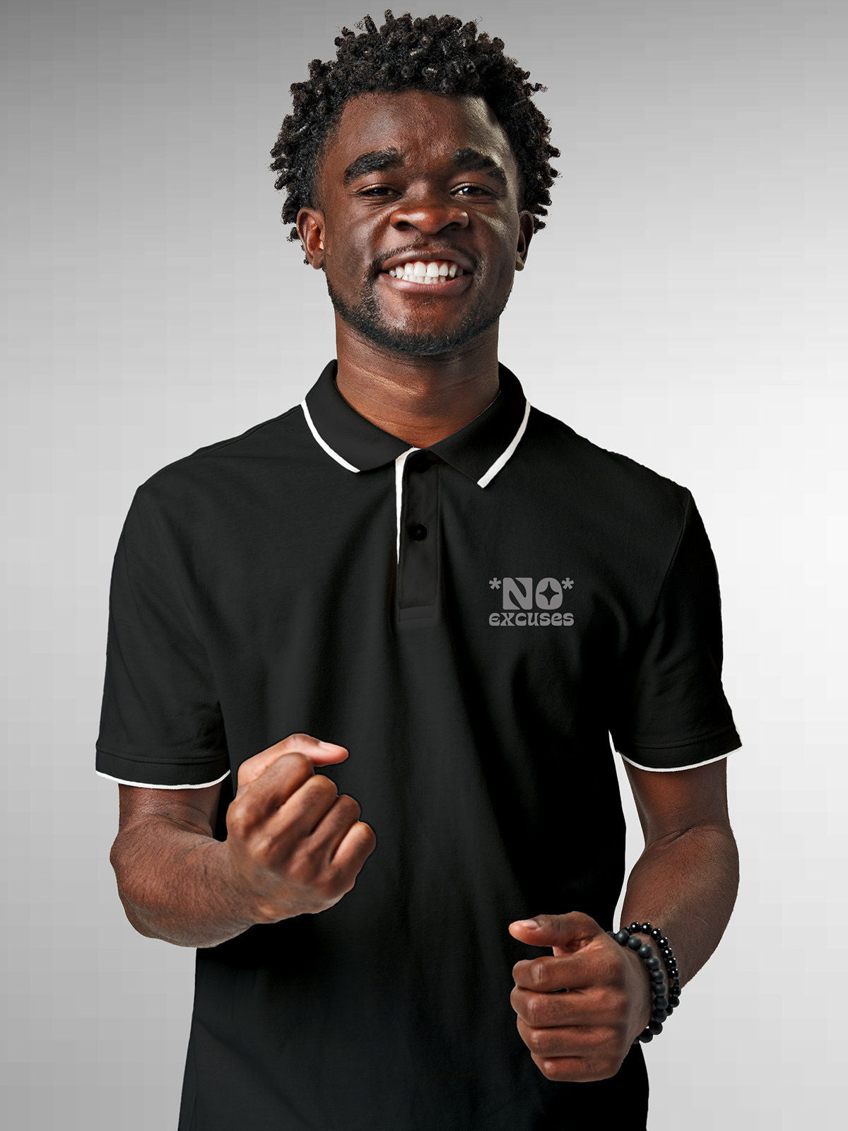 Model wearing Men's Dark Grey Polo T-shirt with 'No Excuses' design, offering effortless style and premium comfort