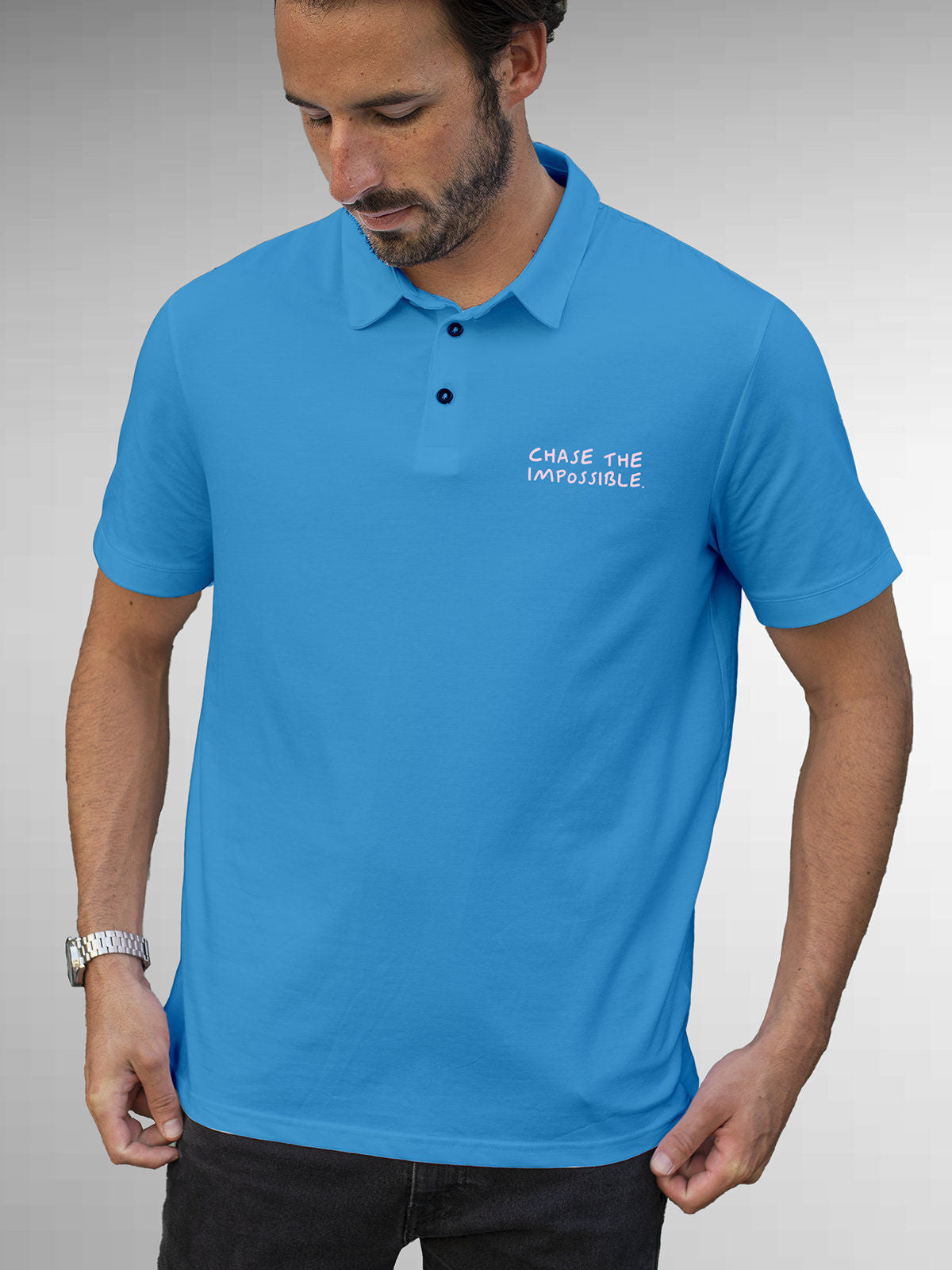 Model wearing Men's Blue Polo T-shirt with 'Chase The Impossible' design, offering effortless style and premium comfort