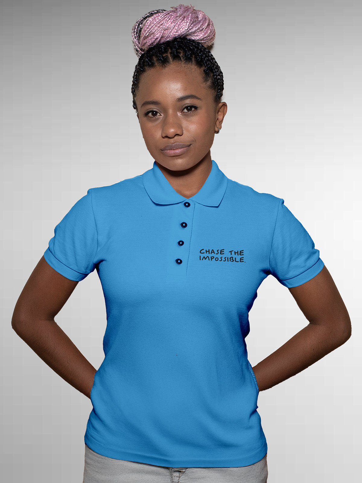 Model wearing Women's Blue Polo T-shirt with 'Chase The Impossible' design, offering effortless style and premium comfort