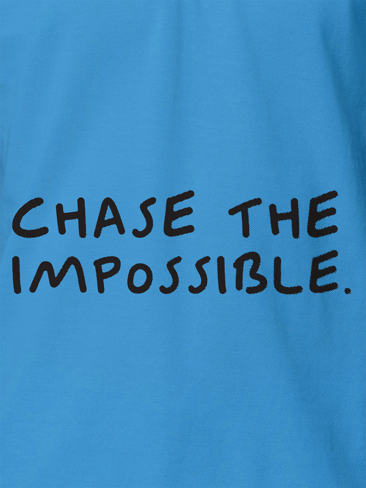 Close up of 'Chase The Impossible' design on Women's Blue Polo T-shirt, highlighting intricate details and vibrant print.