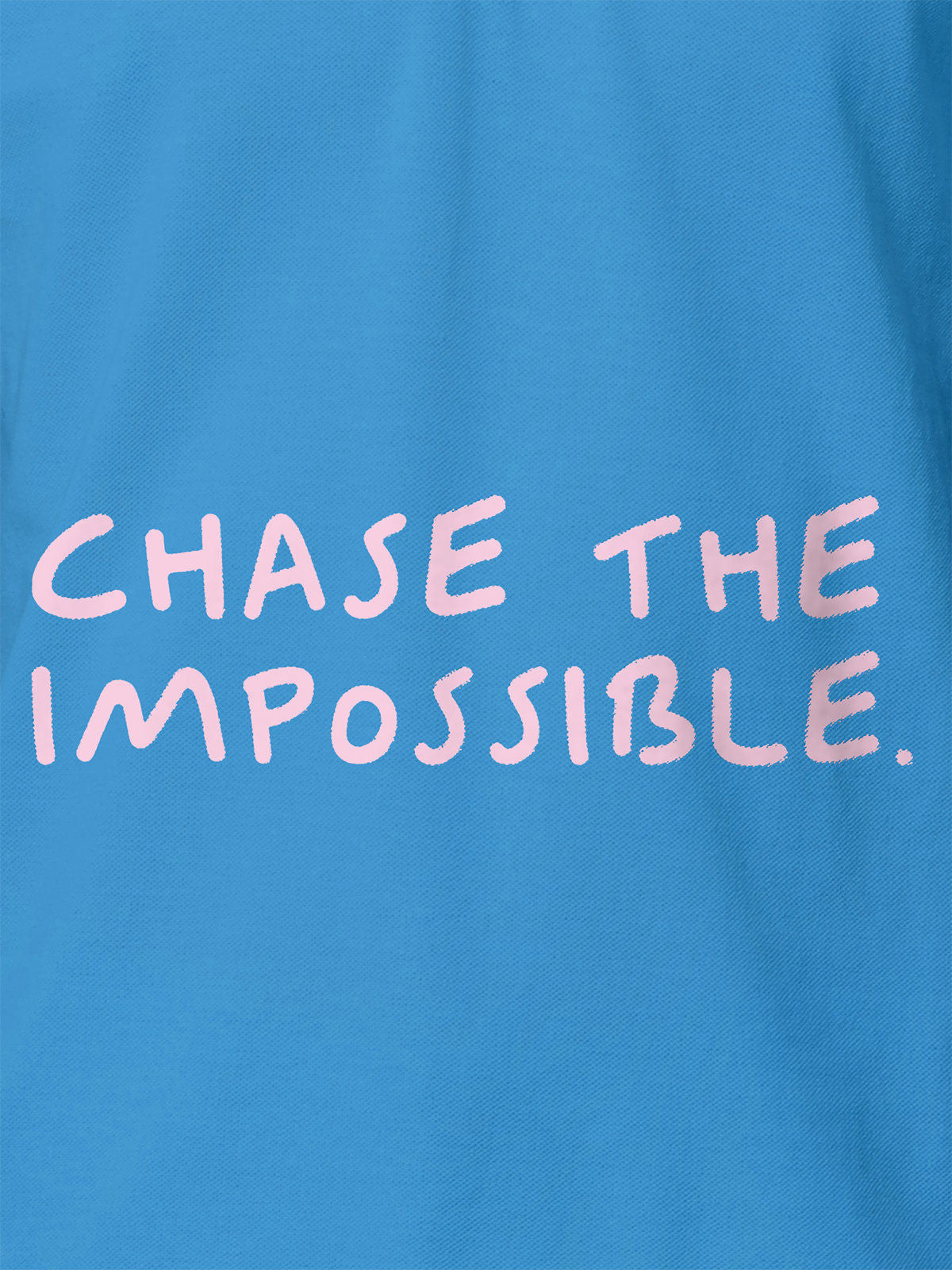 Close up of 'Chase The Impossible' design on Women's Blue Polo T-shirt, highlighting intricate details and vibrant print.
