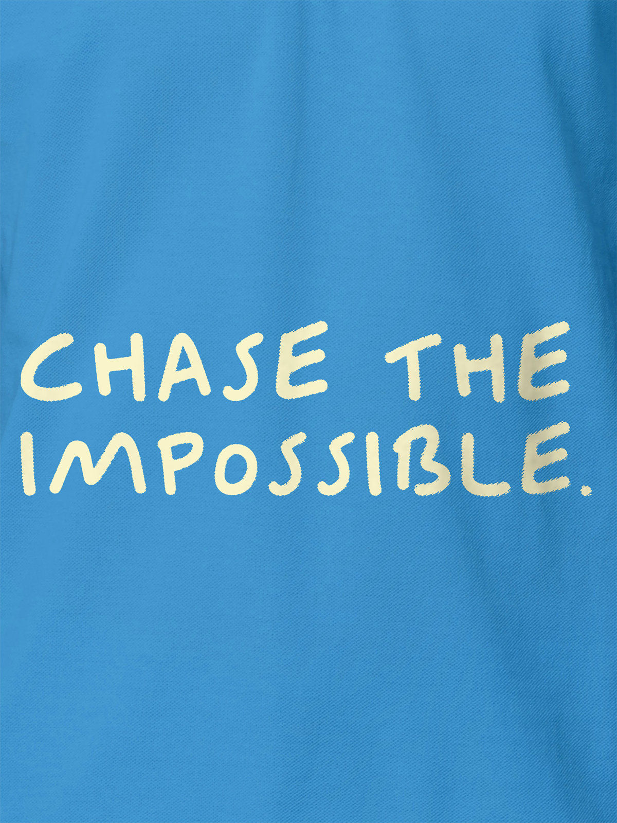 Close up of 'Chase The Impossible' design on Women's Blue Polo T-shirt, highlighting intricate details and vibrant print.