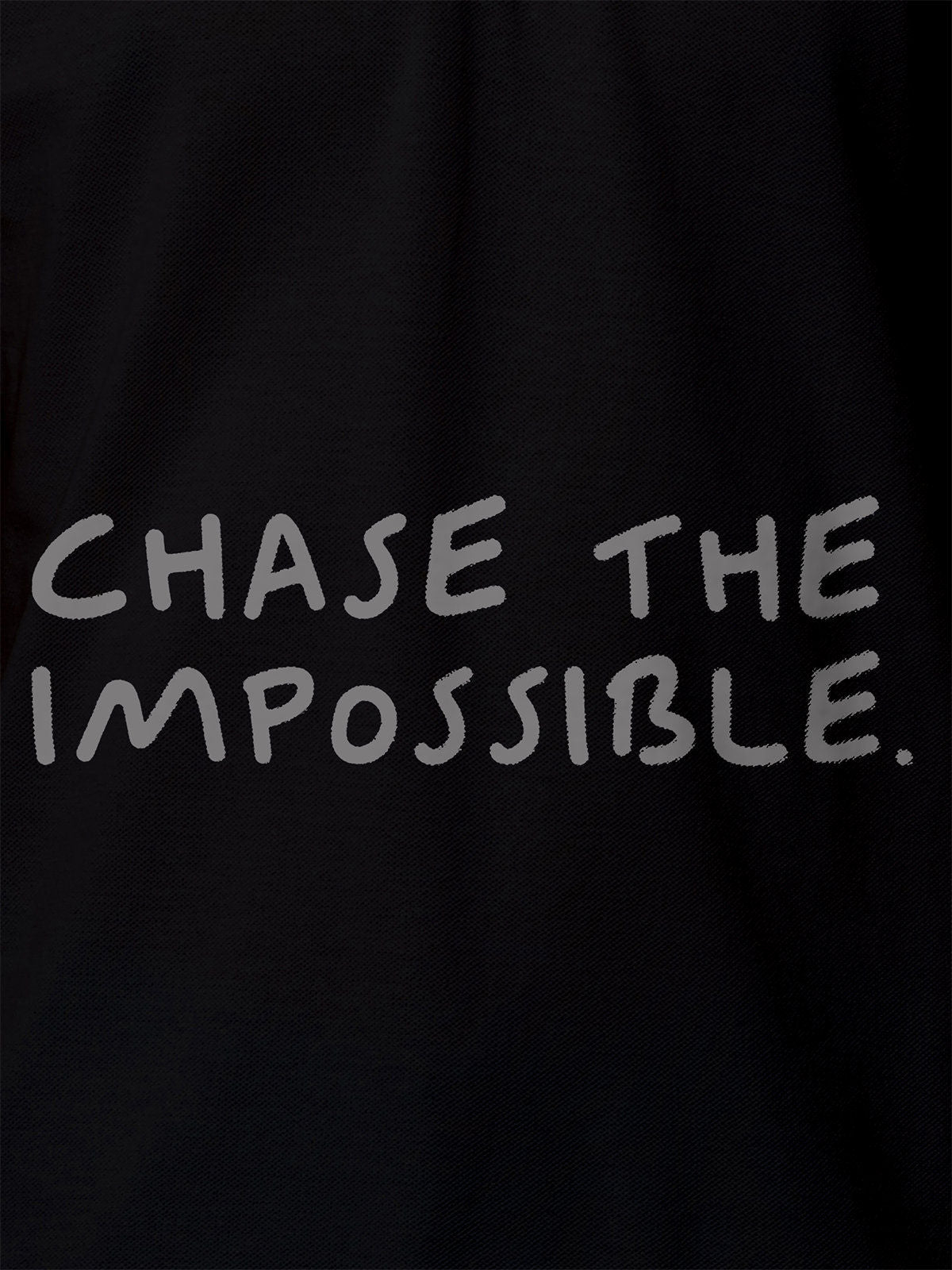 Close up of 'Chase The Impossible' design on Women's Black Polo T-shirt, highlighting intricate details and vibrant print.