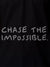 Close up of 'Chase The Impossible' design on Women's Black Polo T-shirt, highlighting intricate details and vibrant print.