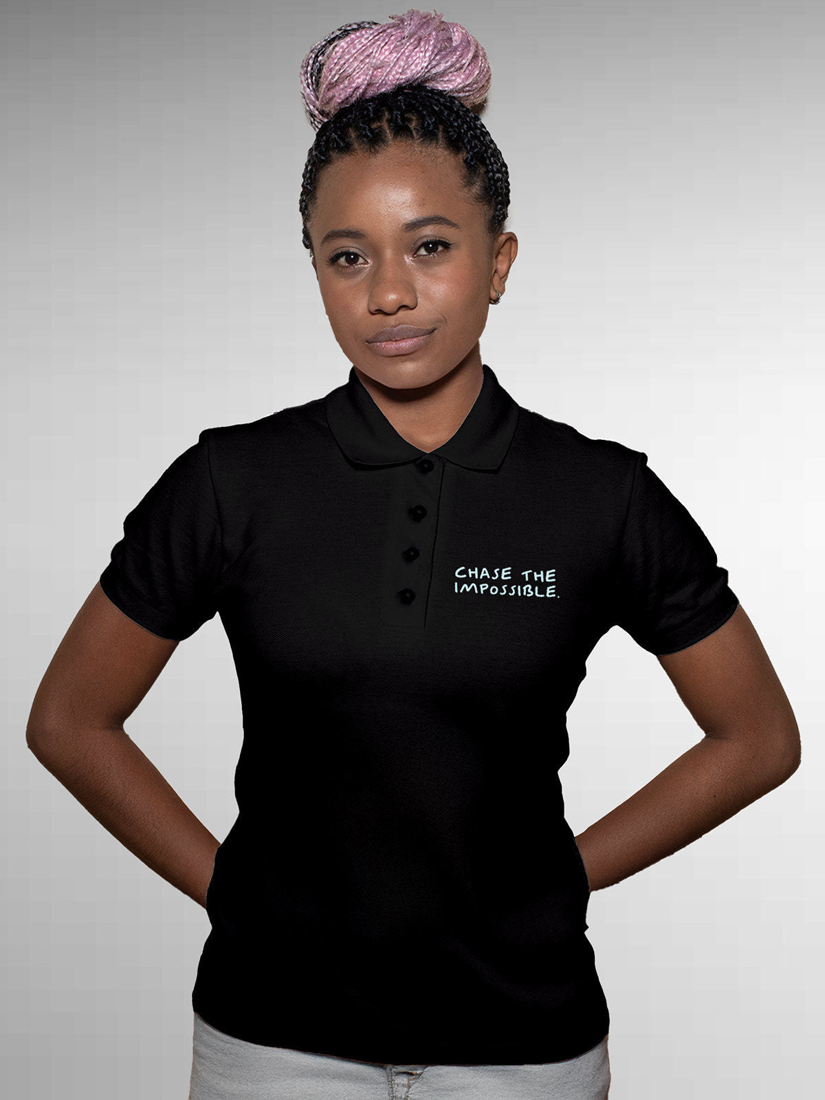 Model wearing Women's Black Polo T-shirt with 'Chase The Impossible' design, offering effortless style and premium comfort