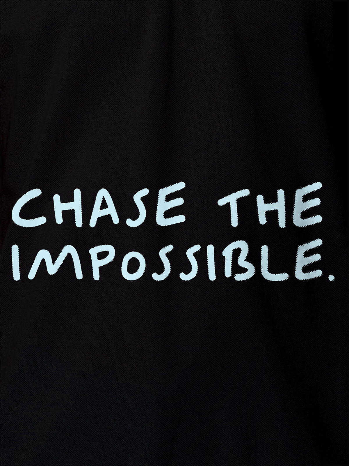 Close up of 'Chase The Impossible' design on Women's Black Polo T-shirt, highlighting intricate details and vibrant print.