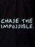 Close up of 'Chase The Impossible' design on Women's Black Polo T-shirt, highlighting intricate details and vibrant print.