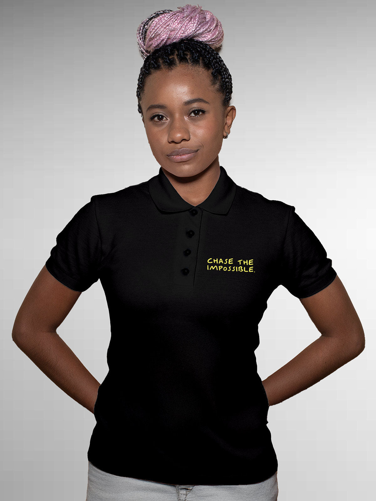 Model wearing Women's Black Polo T-shirt with 'Chase The Impossible' design, offering effortless style and premium comfort