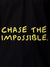 Close up of 'Chase The Impossible' design on Women's Black Polo T-shirt, highlighting intricate details and vibrant print.