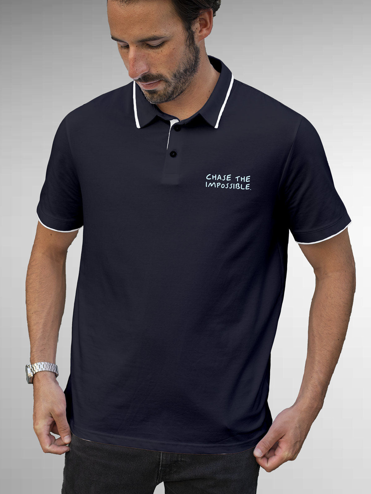 Model wearing Men's Navy Blue Polo T-shirt with 'Chase The Impossible' design, offering effortless style and premium comfort