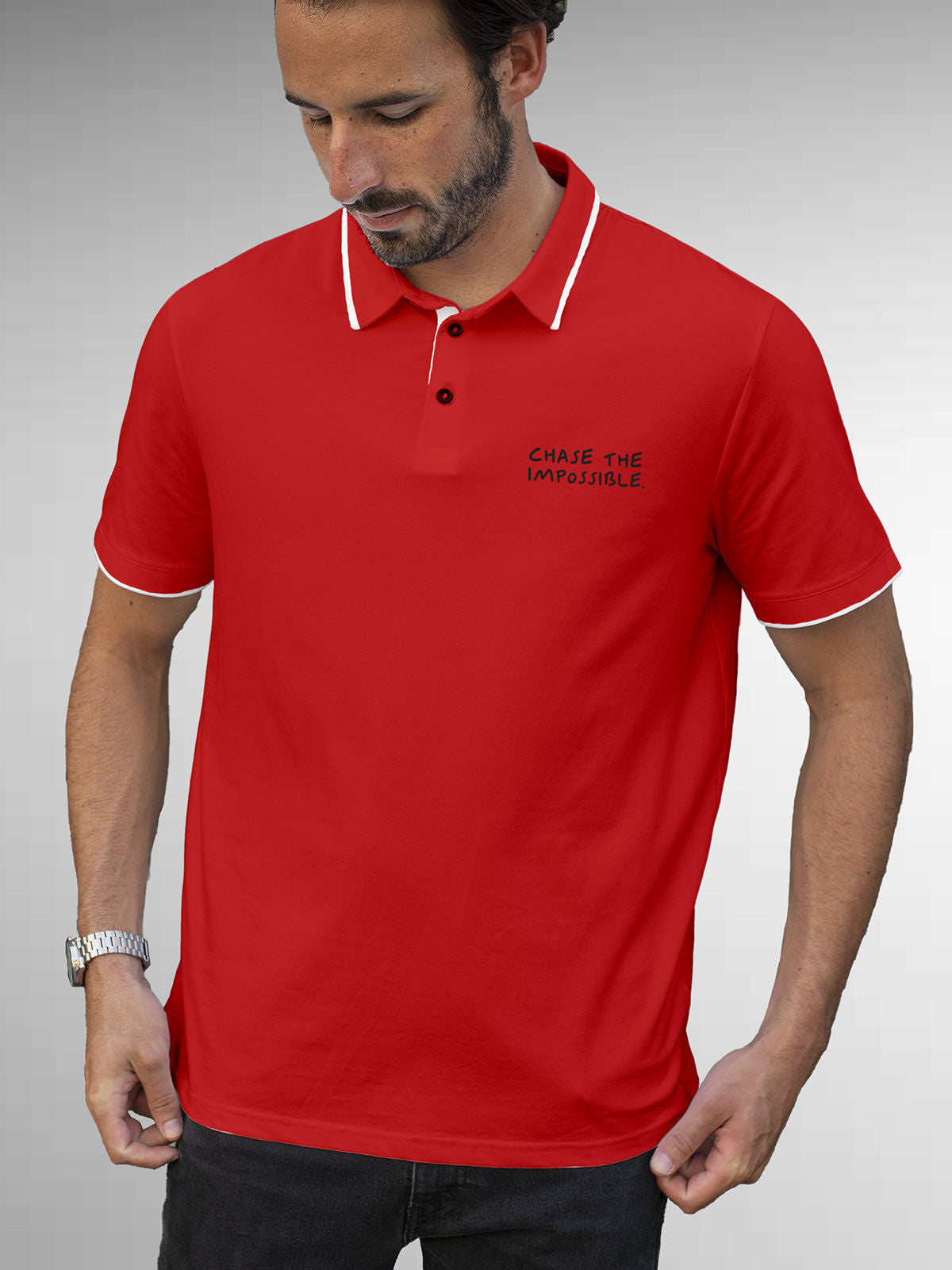 Model wearing Men's Red Polo T-shirt with 'Chase The Impossible' design, offering effortless style and premium comfort