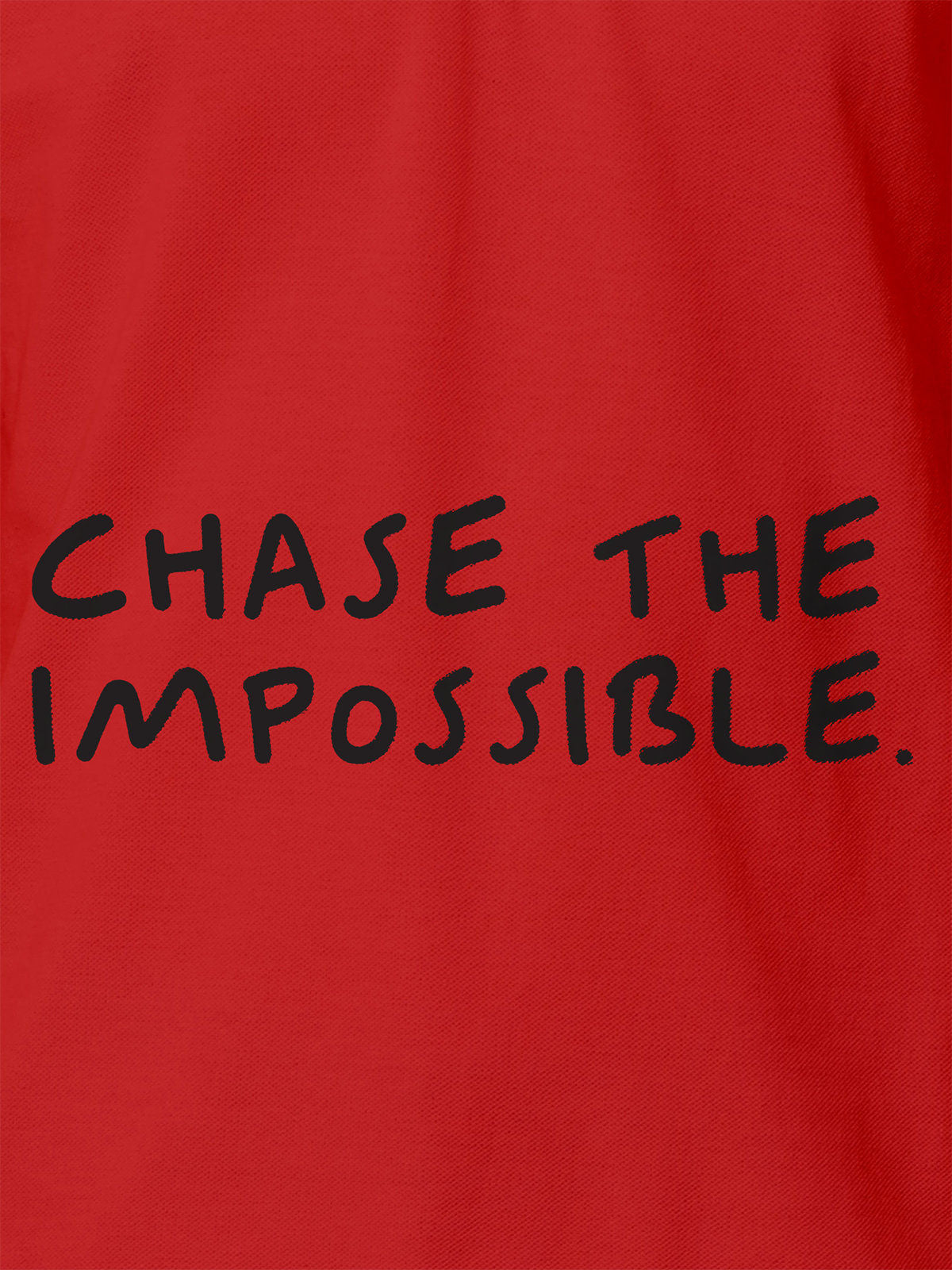 Close up of 'Chase The Impossible' design on Women's Red Polo T-shirt, highlighting intricate details and vibrant print.
