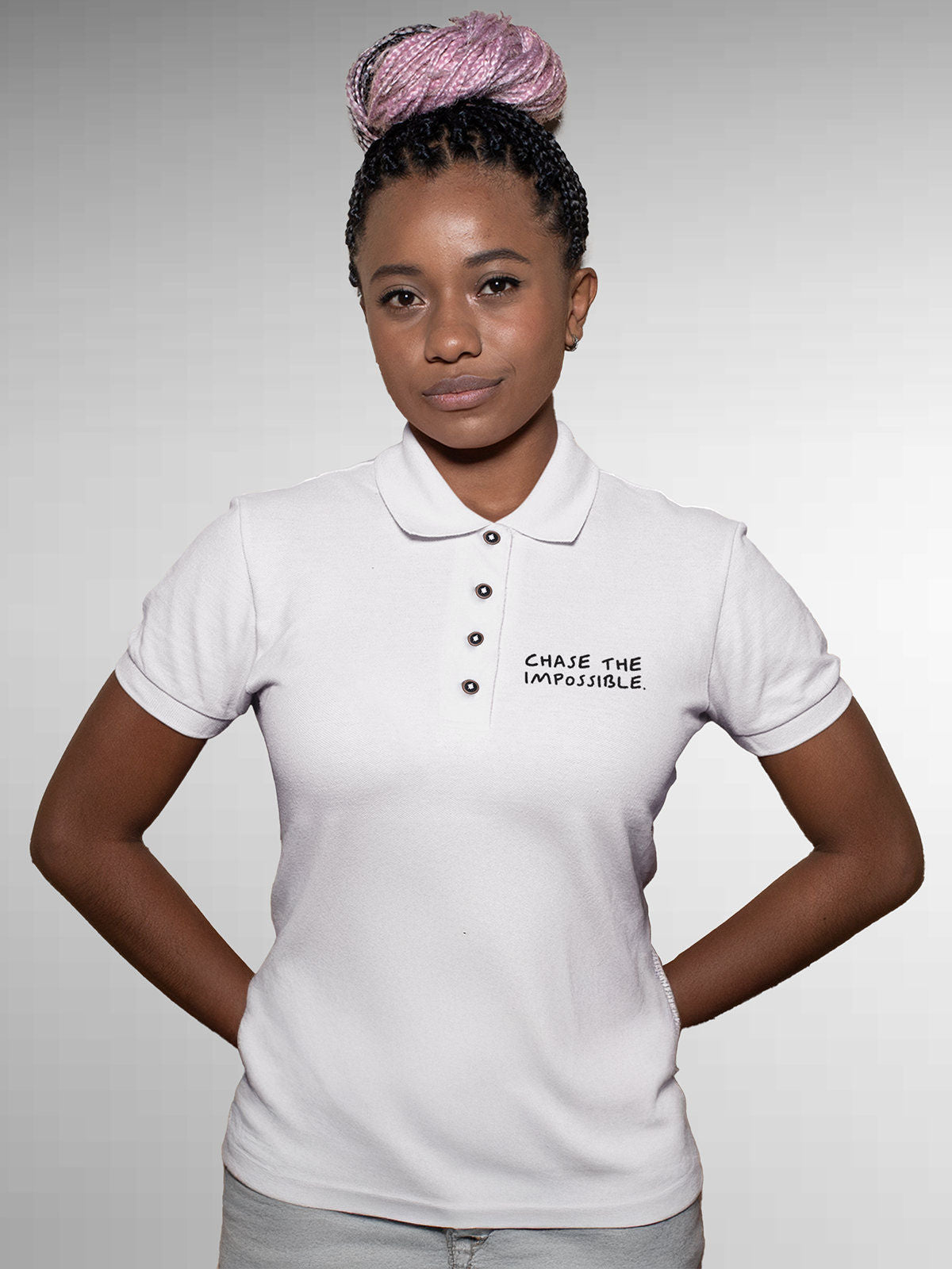 Model wearing Women's White Polo T-shirt with 'Chase The Impossible' design, offering effortless style and premium comfort