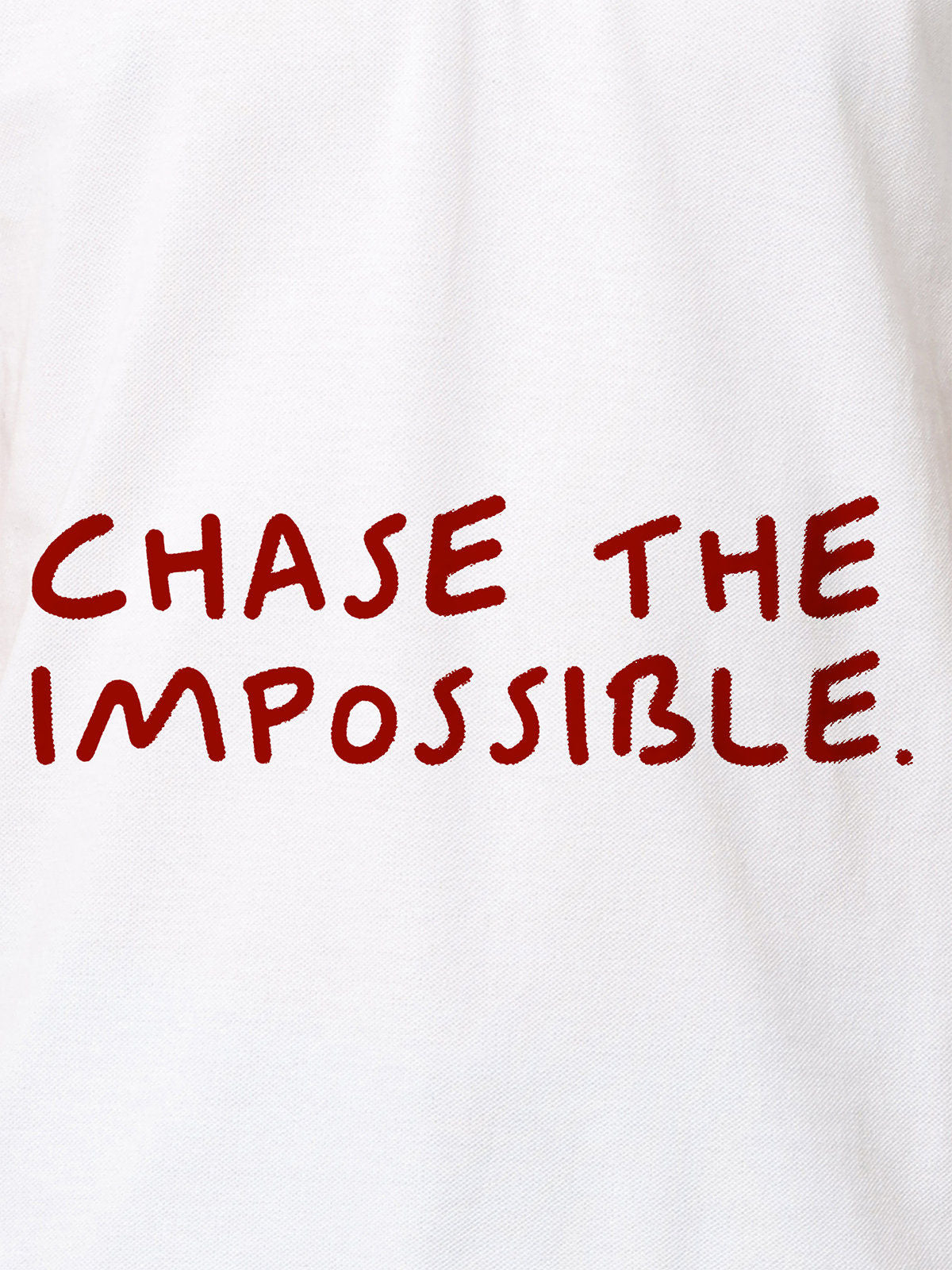 Close up of 'Chase The Impossible' design on Women's White Polo T-shirt, highlighting intricate details and vibrant print.