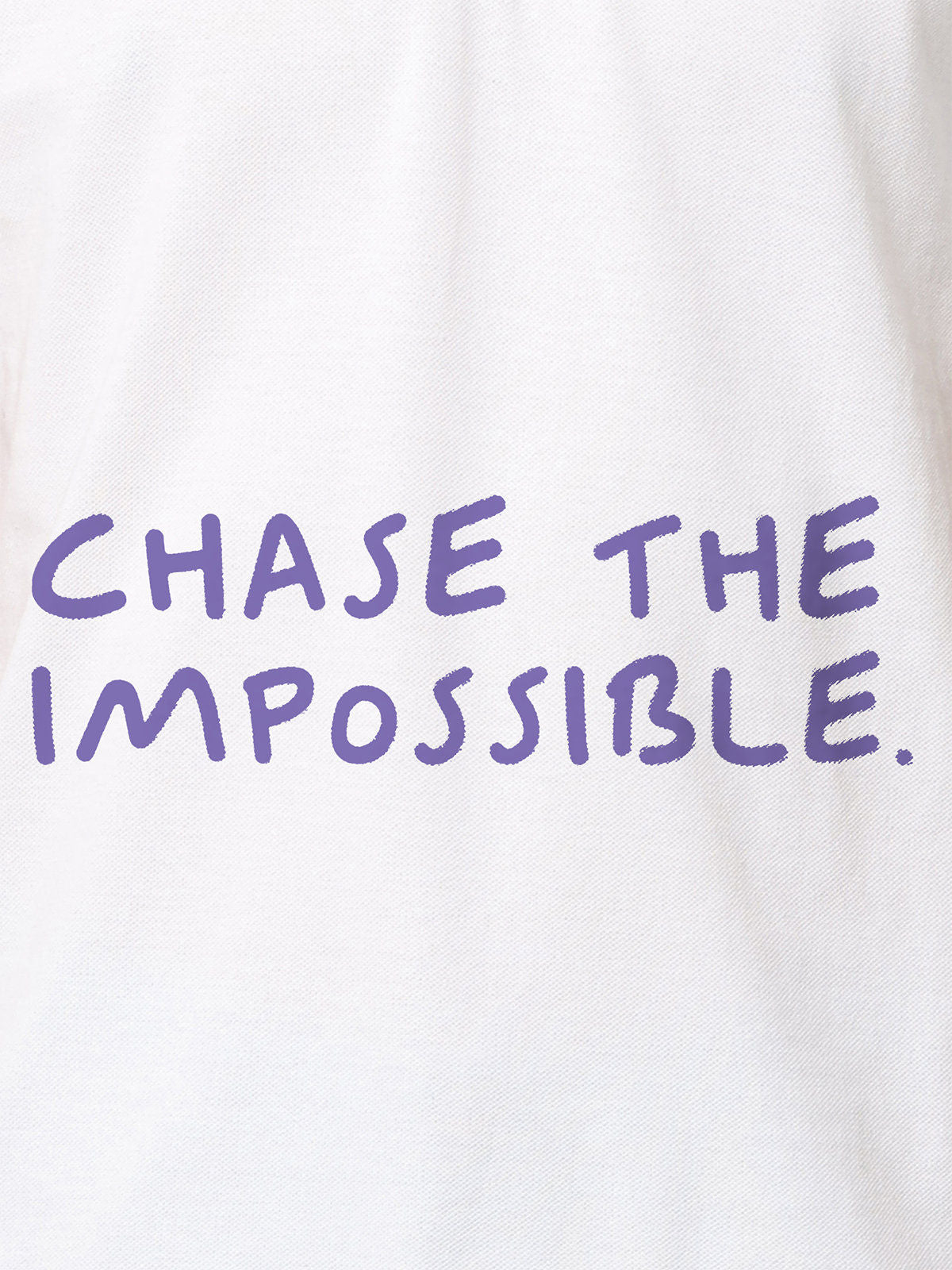 Close up of 'Chase The Impossible' design on Women's White Polo T-shirt, highlighting intricate details and vibrant print.