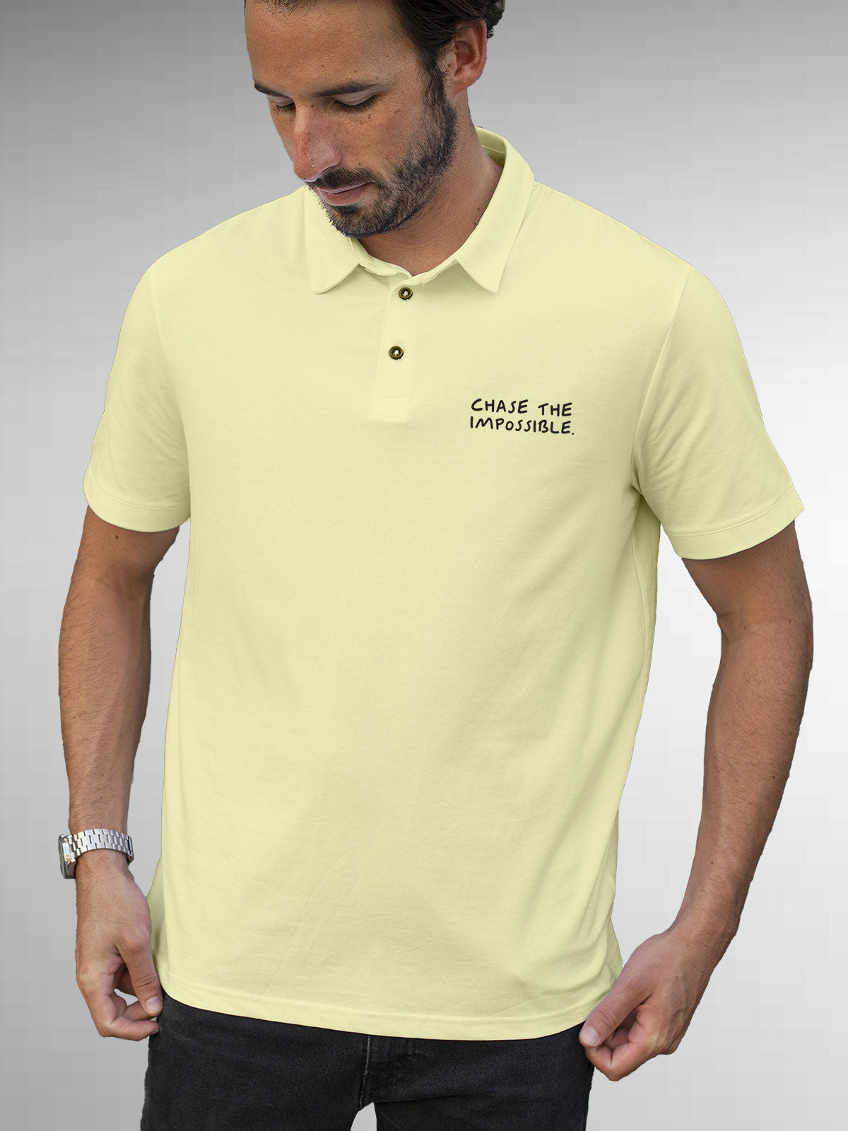 Model wearing Men's Yellow Polo T-shirt with 'Chase The Impossible' design, offering effortless style and premium comfort