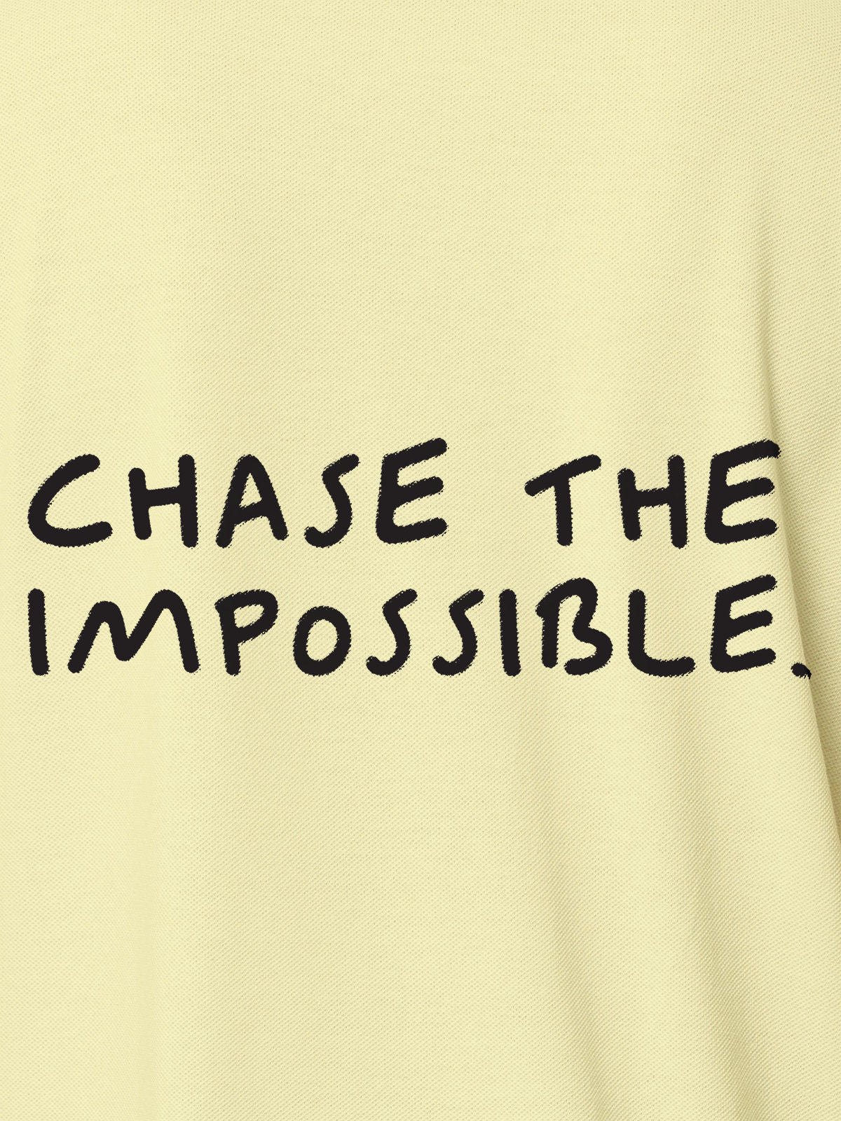 Close up of 'Chase The Impossible' design on Men's Yellow Polo T-shirt, highlighting intricate details and vibrant print.