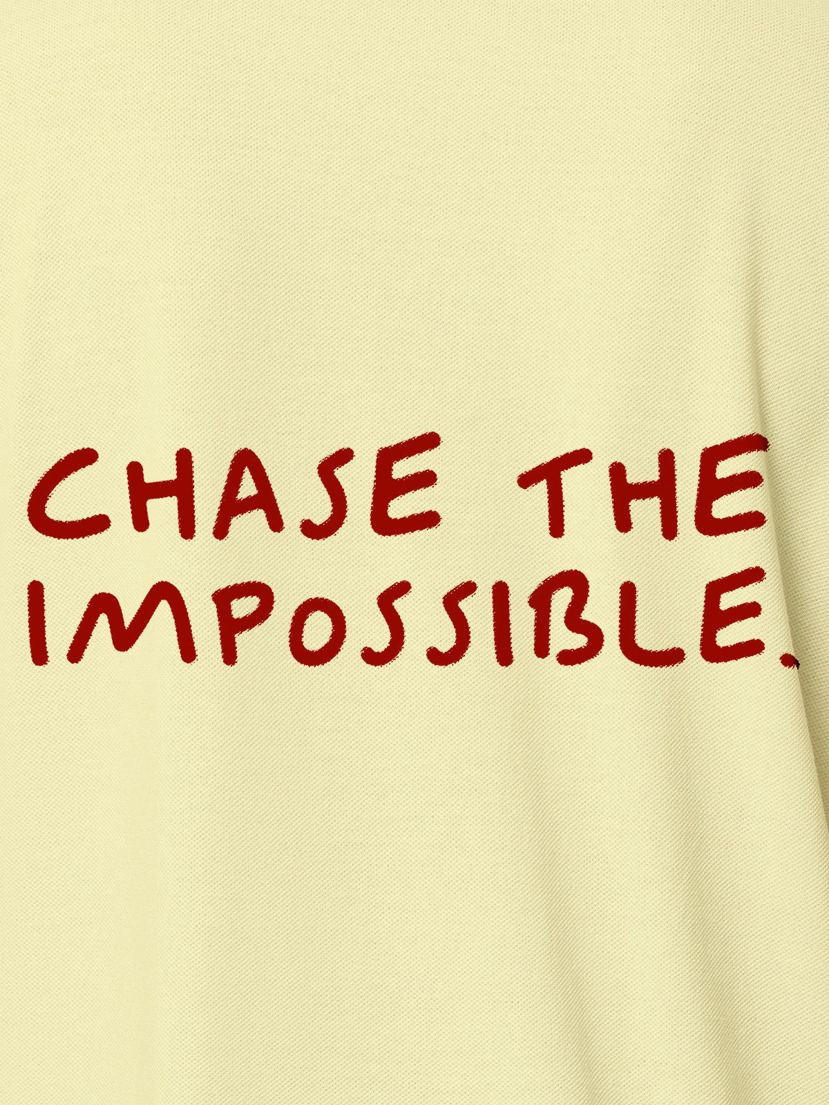 Close up of 'Chase The Impossible' design on Men's Yellow Polo T-shirt, highlighting intricate details and vibrant print.