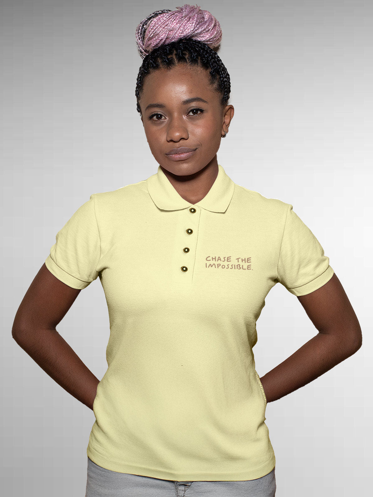 Model wearing Women's Yellow Polo T-shirt with 'Chase The Impossible' design, offering effortless style and premium comfort