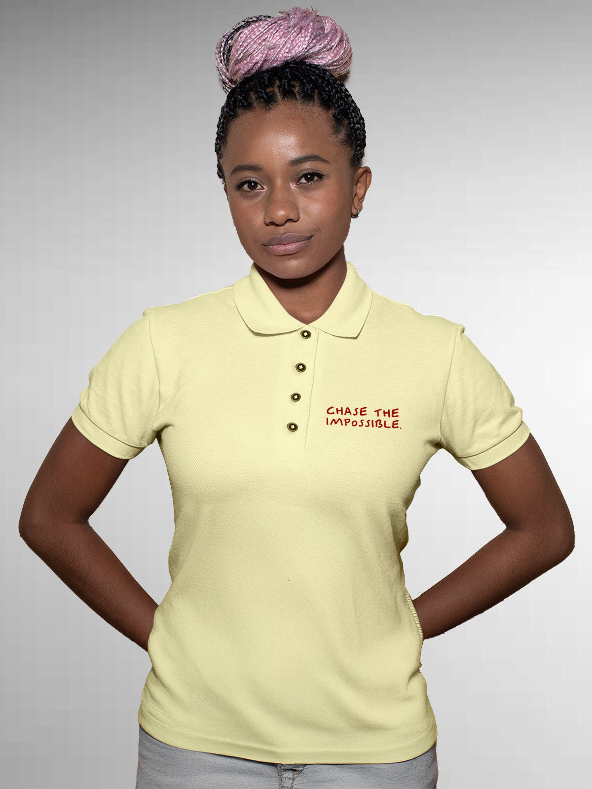 Model wearing Women's Yellow Polo T-shirt with 'Chase The Impossible' design, offering effortless style and premium comfort