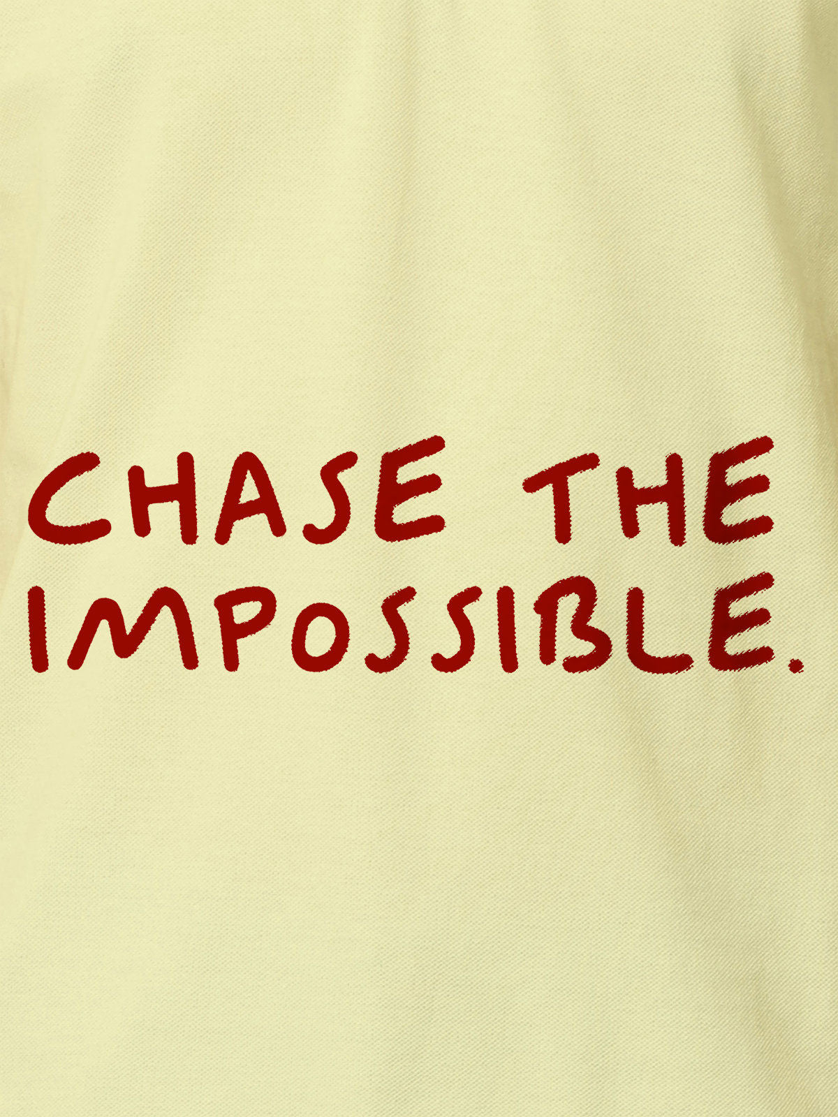 Close up of 'Chase The Impossible' design on Women's Yellow Polo T-shirt, highlighting intricate details and vibrant print.