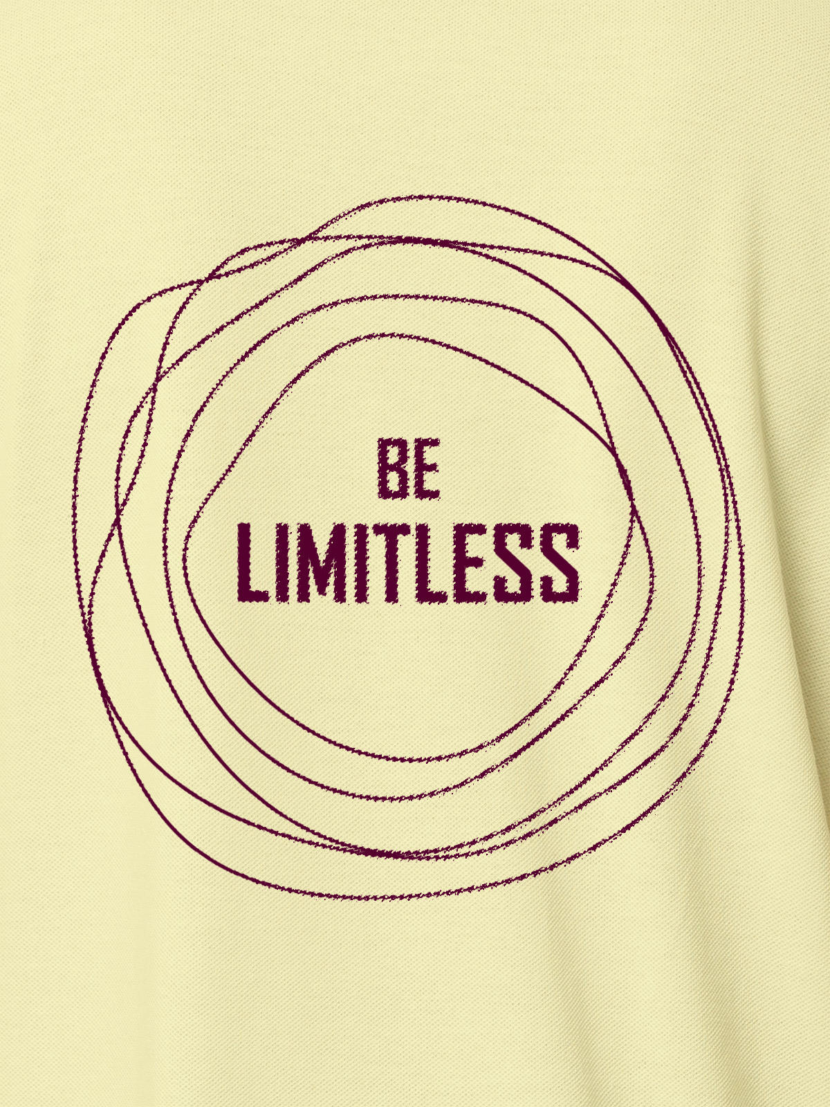 Close up of 'Be Limitless' design on Men's Yellow Polo T-shirt, highlighting intricate details and vibrant print.