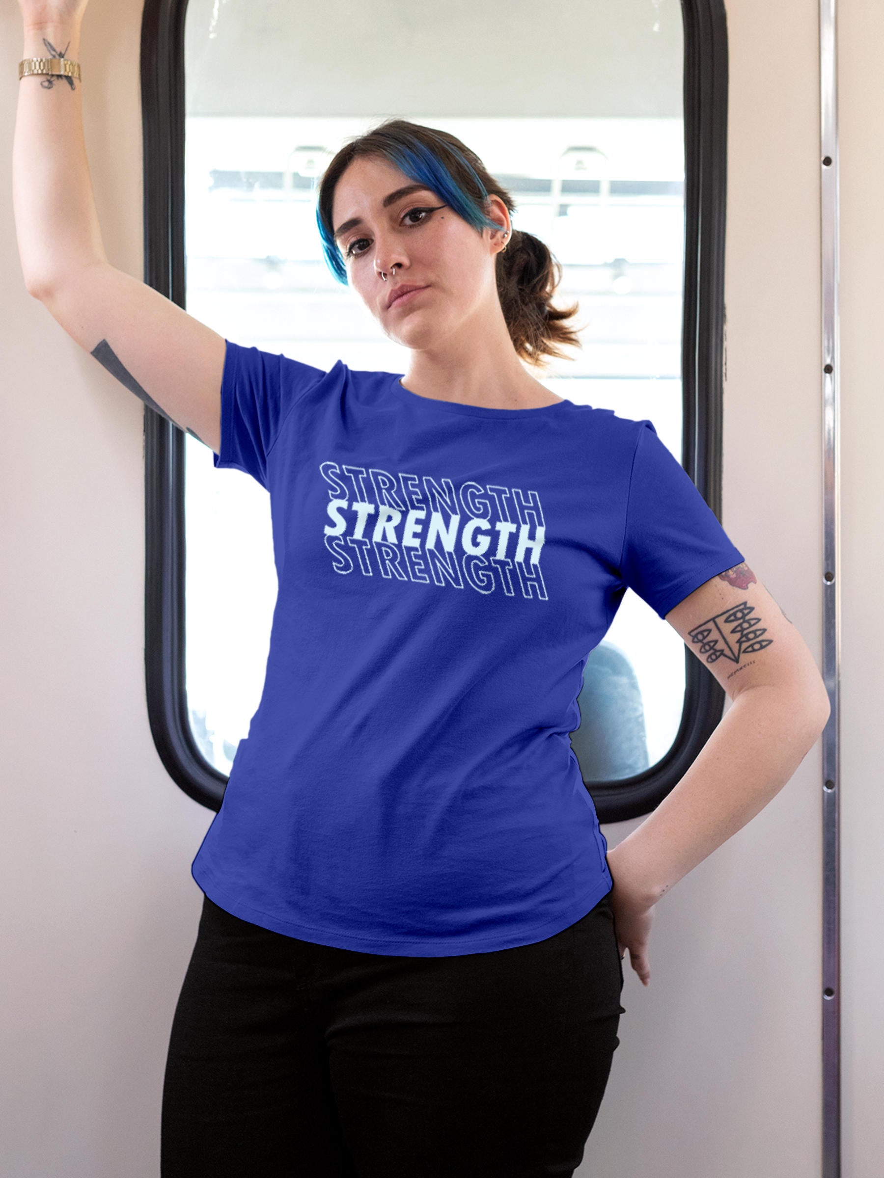 Model wearing Women's Blue Round Neck T-shirt with 'Strength' design, offering effortless style and premium comfort