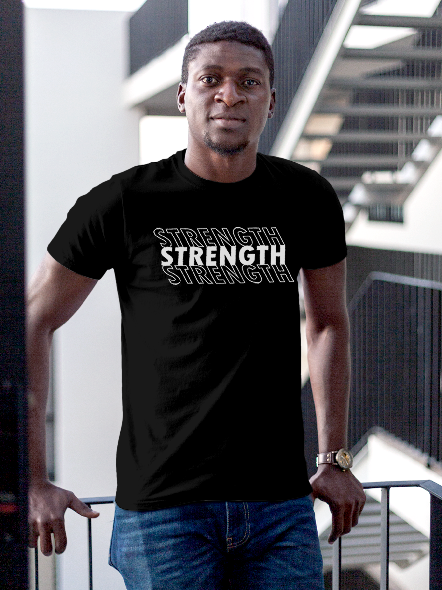 Model wearing Men's Black Round Neck T-shirt with 'Strength' design, offering effortless style and premium comfort