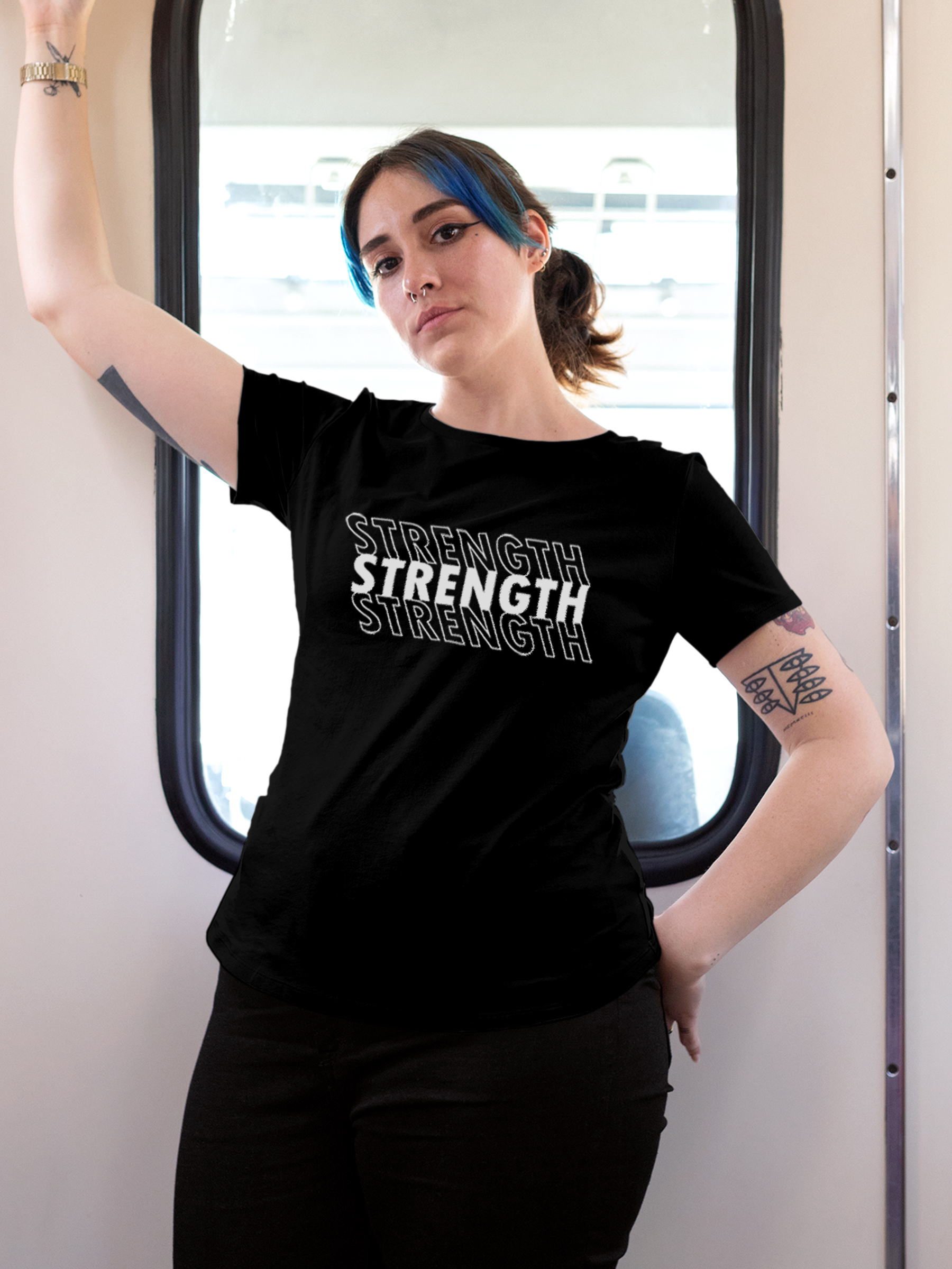 Model wearing Women's Black Round Neck T-shirt with 'Strength' design, offering effortless style and premium comfort