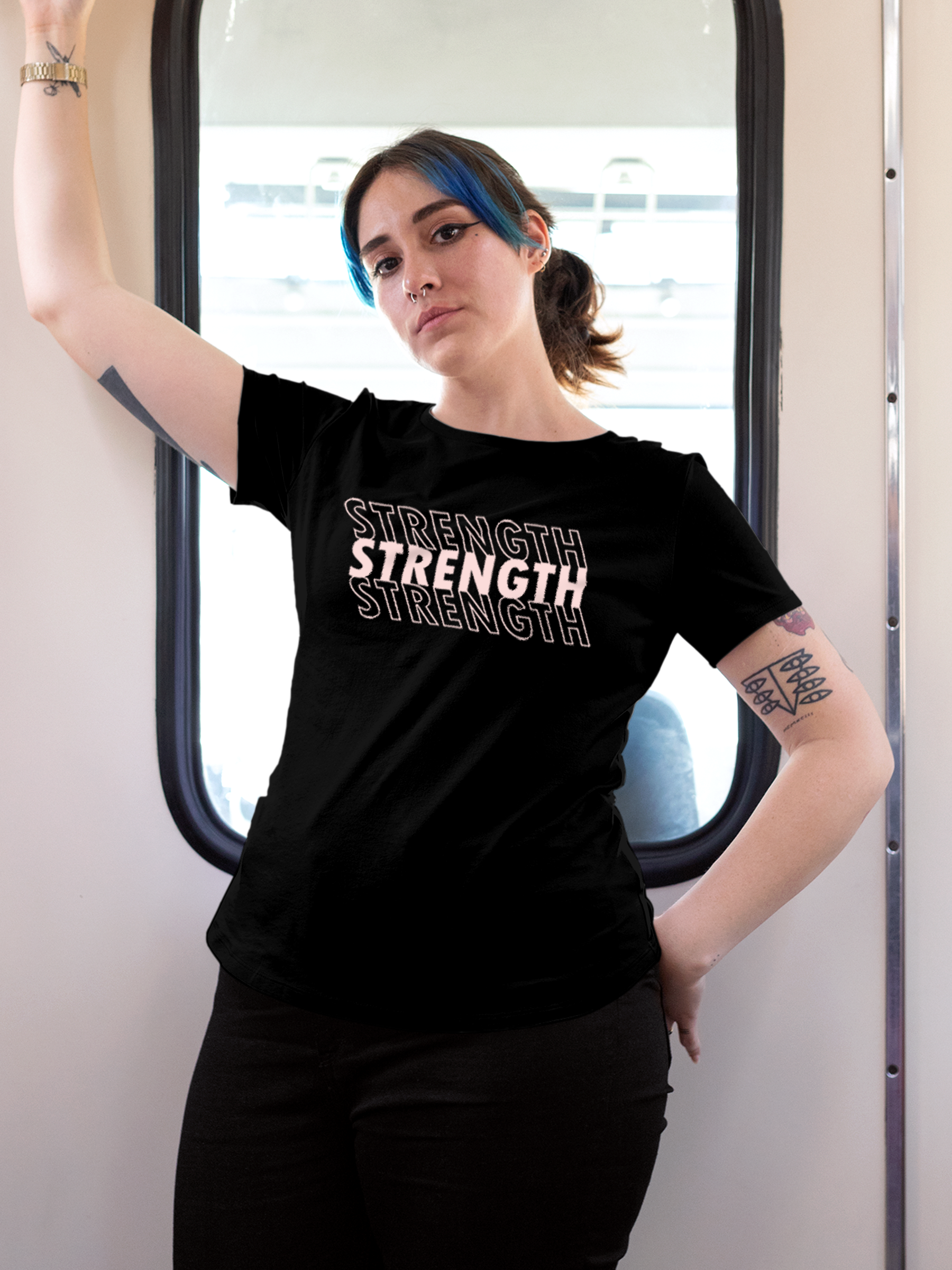 Model wearing Women's Black Round Neck T-shirt with 'Strength' design, offering effortless style and premium comfort