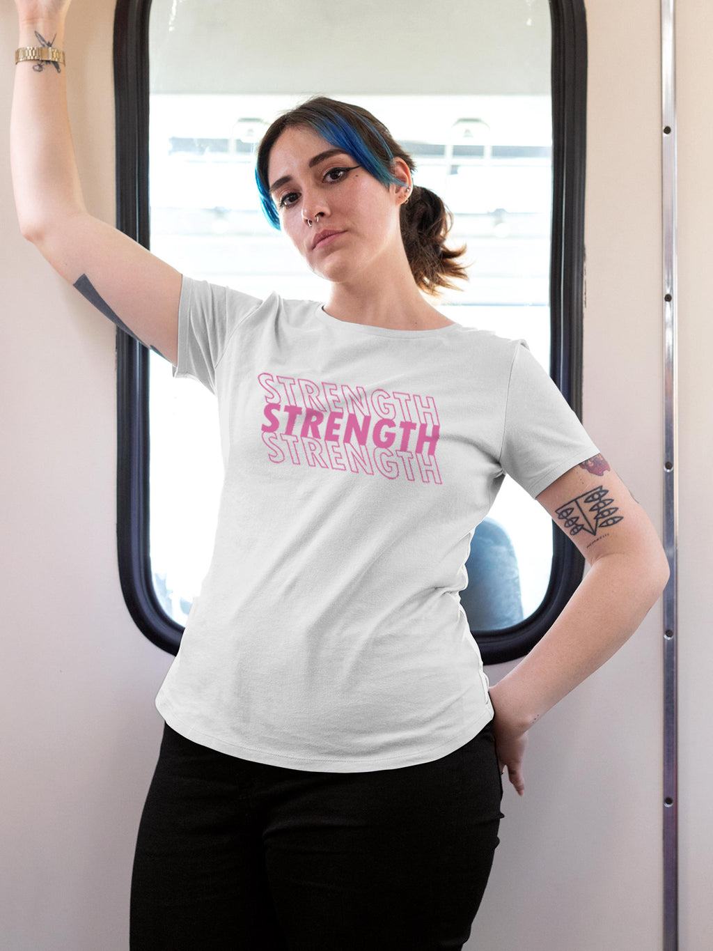 Model wearing Women's White Round Neck T-shirt with 'Strength' design, offering effortless style and premium comfort