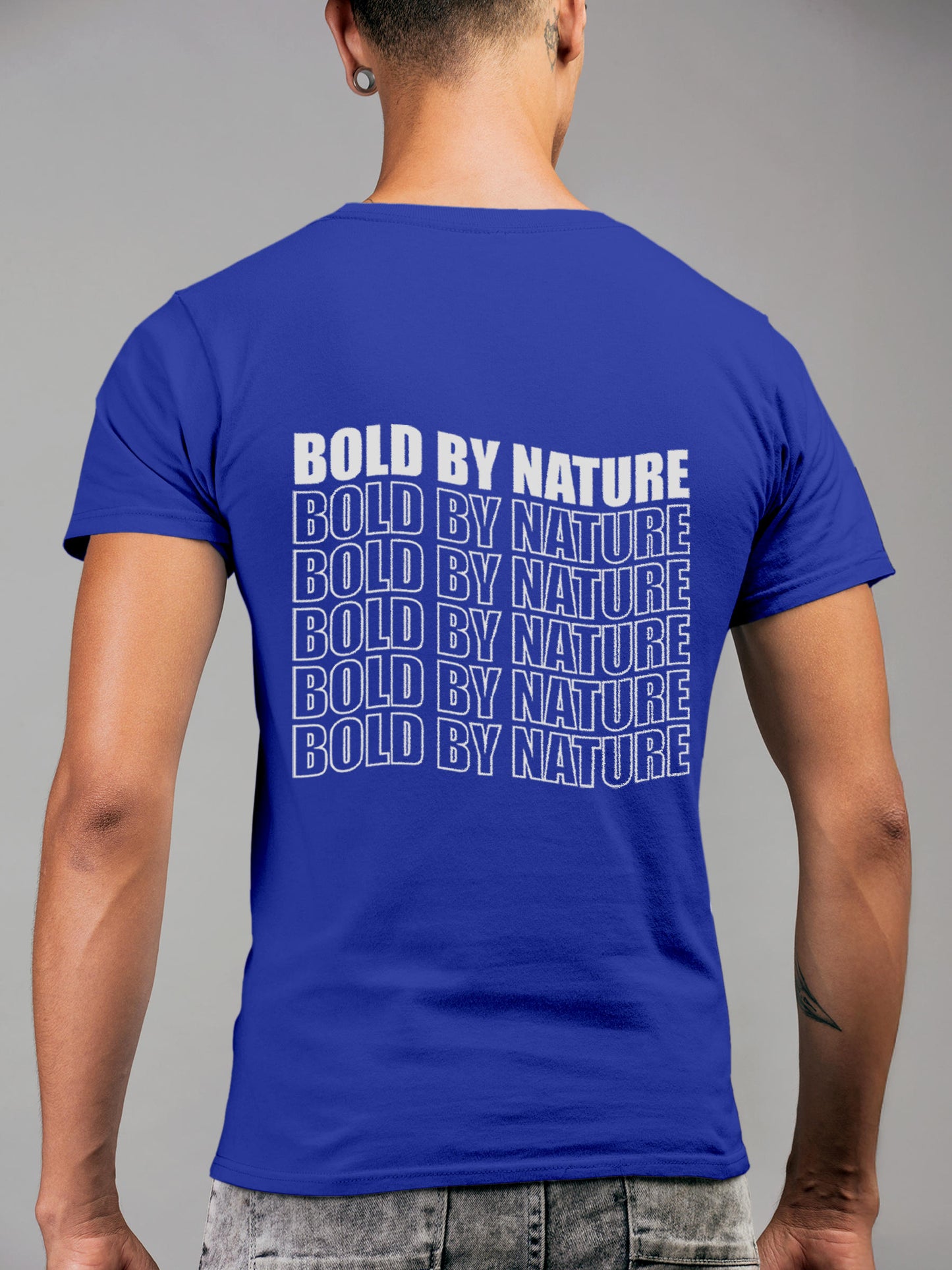 Model wearing Men's Blue Round Neck T-shirt with 'Bold By Nature' design, offering effortless style and premium comfort