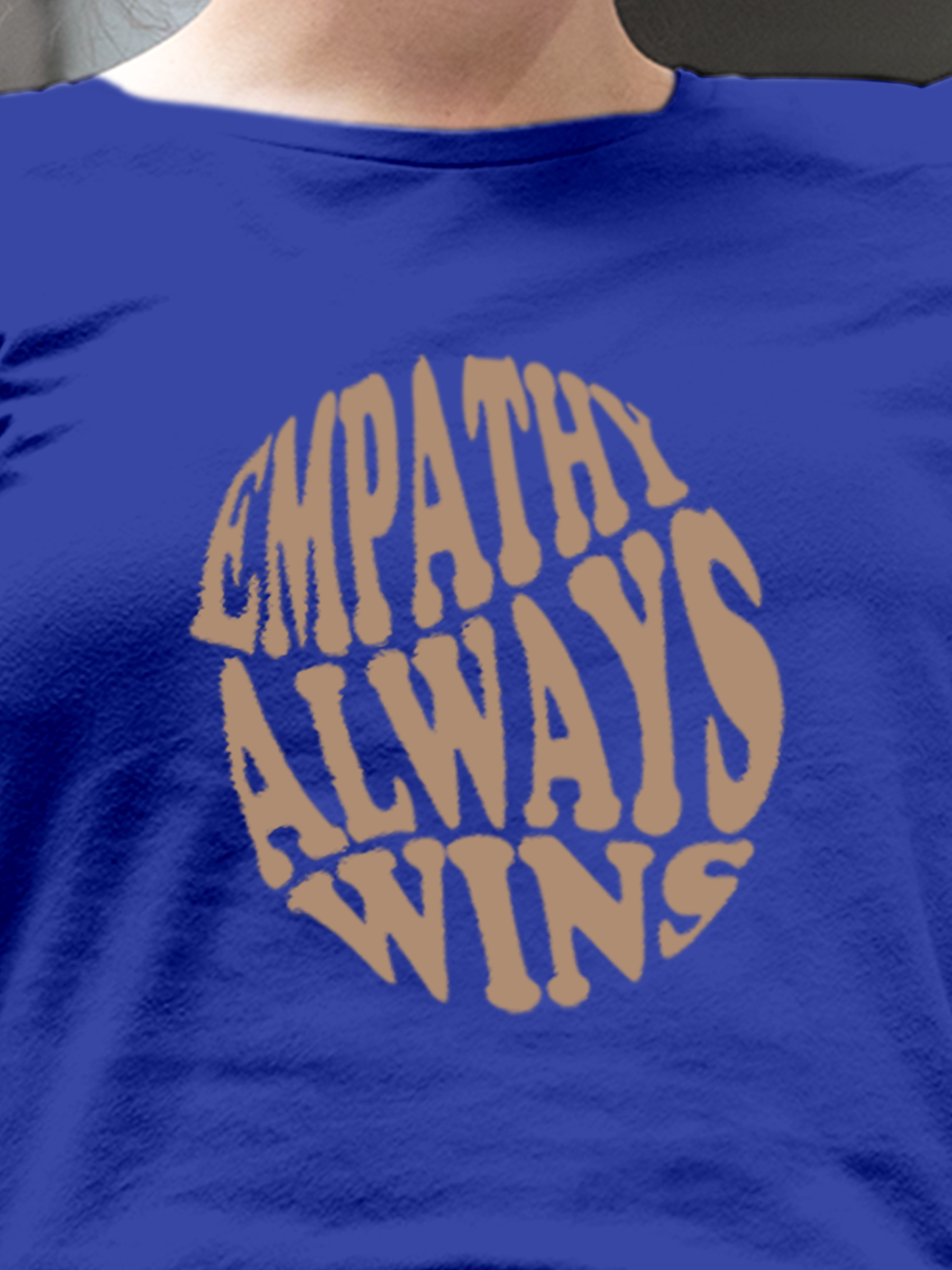 Close up of 'Empathy Always Wins' design on Women's Blue Round Neck T-shirt, highlighting intricate details and vibrant print.