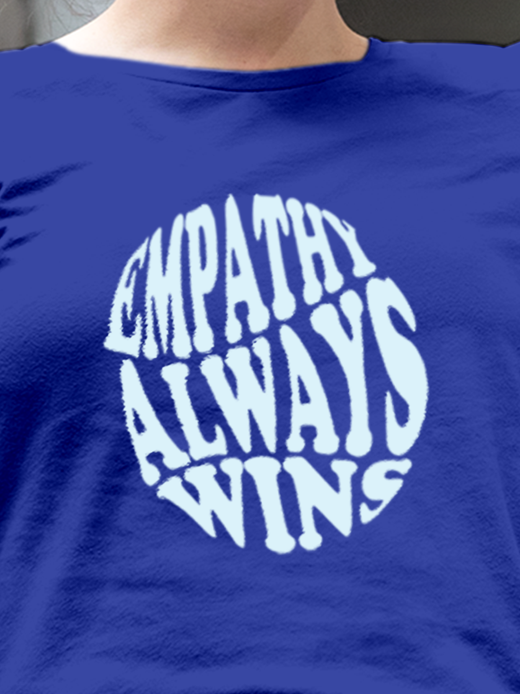 Close up of 'Empathy Always Wins' design on Women's Blue Round Neck T-shirt, highlighting intricate details and vibrant print.