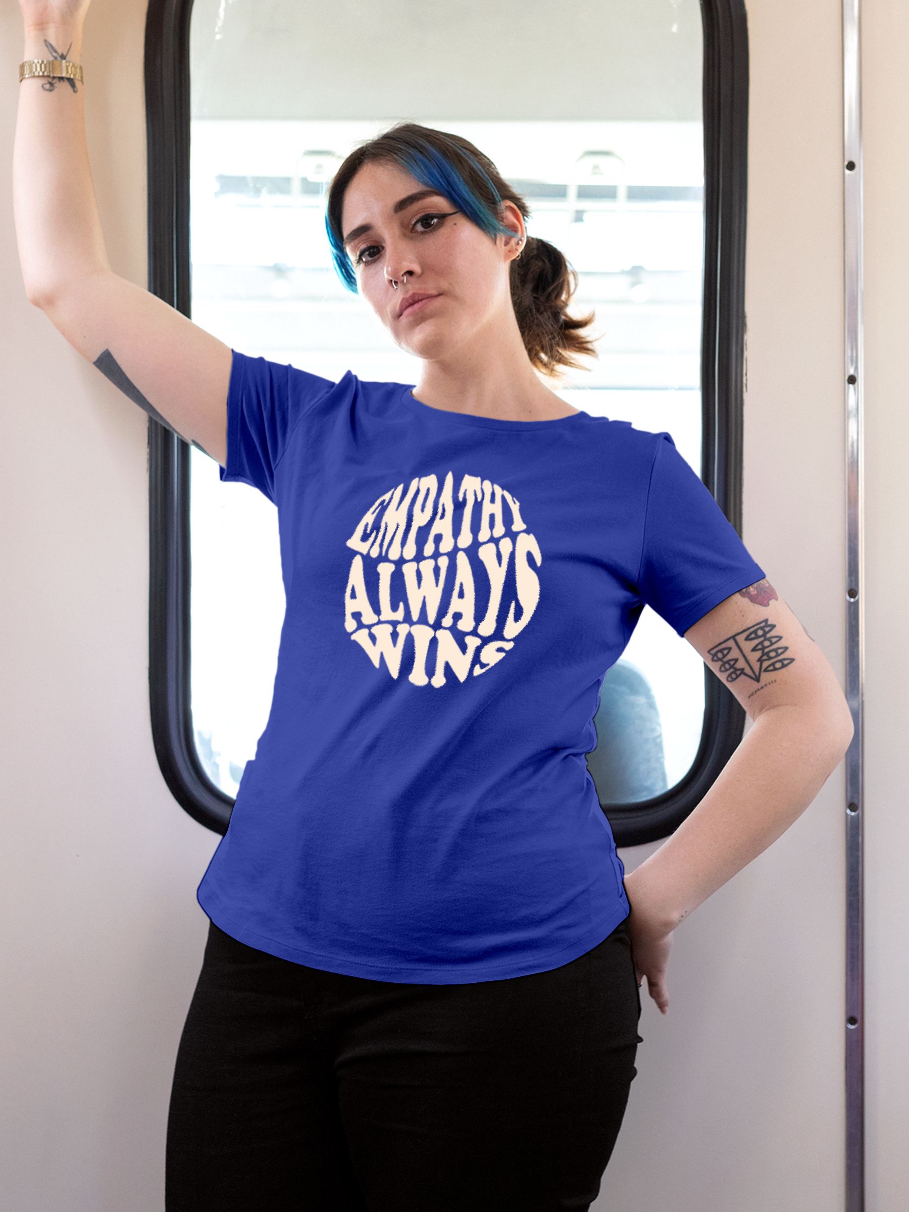 Model wearing Women's Blue Round Neck T-shirt with 'Empathy Always Wins' design, offering effortless style and premium comfort