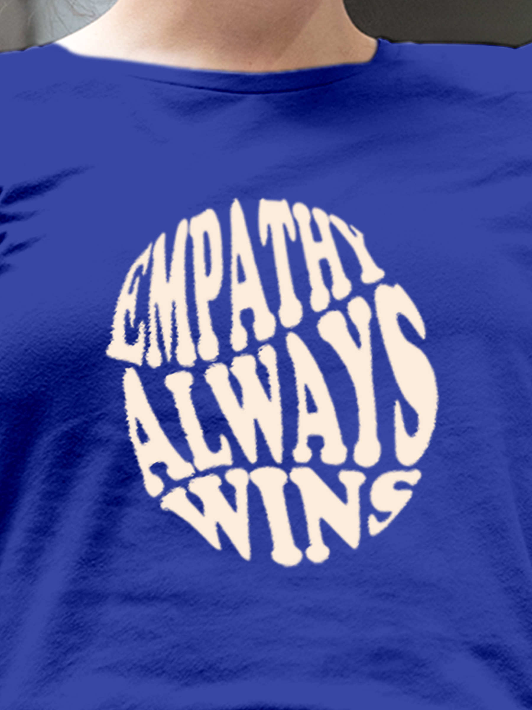 Close up of 'Empathy Always Wins' design on Women's Blue Round Neck T-shirt, highlighting intricate details and vibrant print.