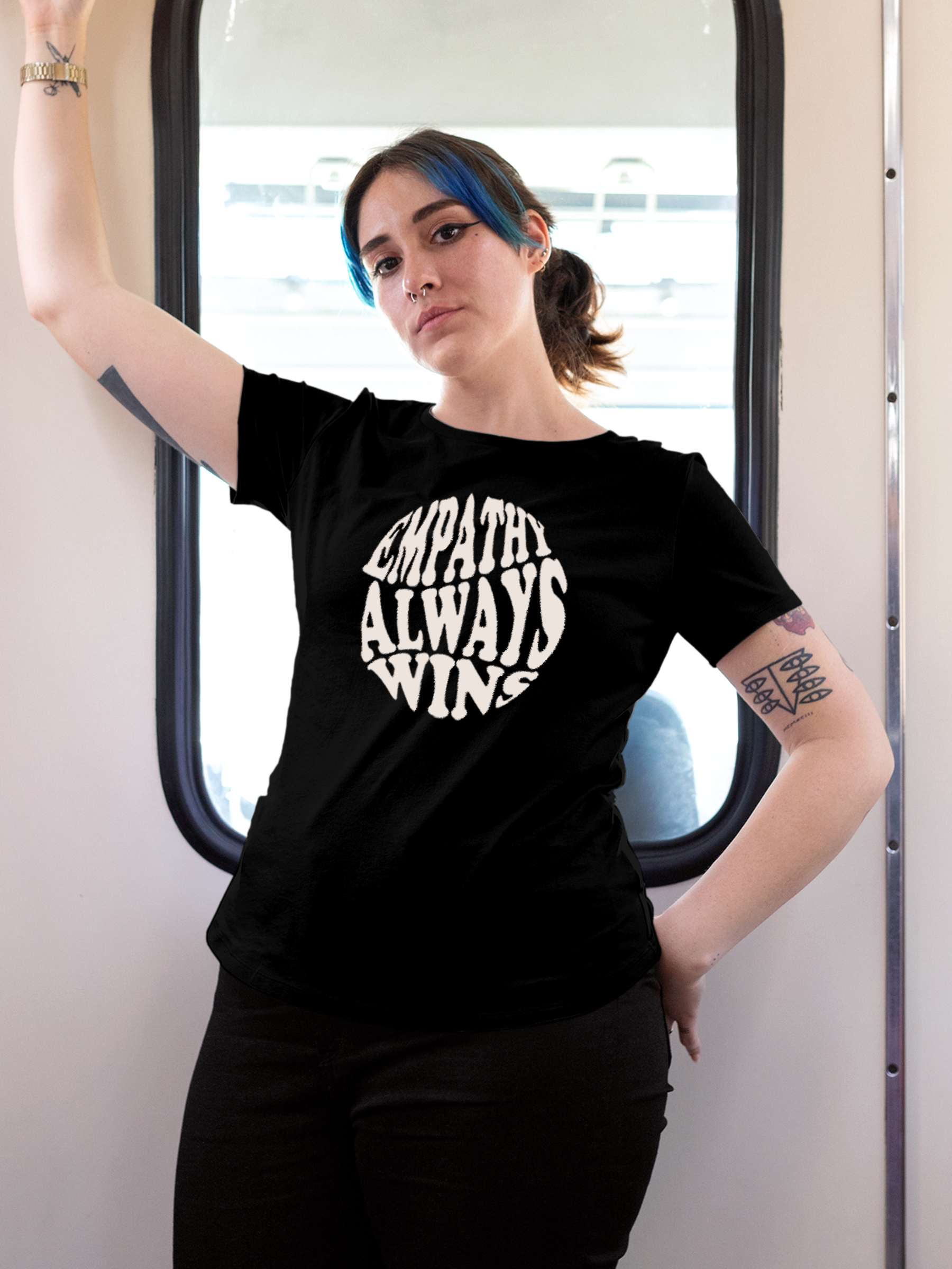 Model wearing Women's Black Round Neck T-shirt with 'Empathy Always Wins' design, offering effortless style and premium comfort