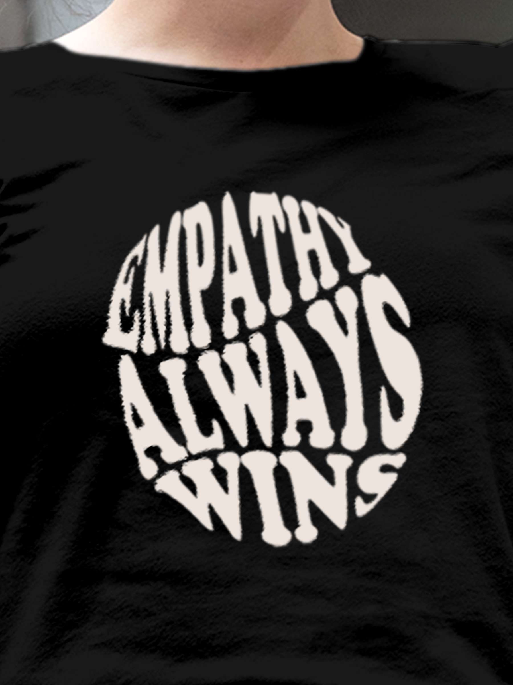 Close up of 'Empathy Always Wins' design on Women's Black Round Neck T-shirt, highlighting intricate details and vibrant print.