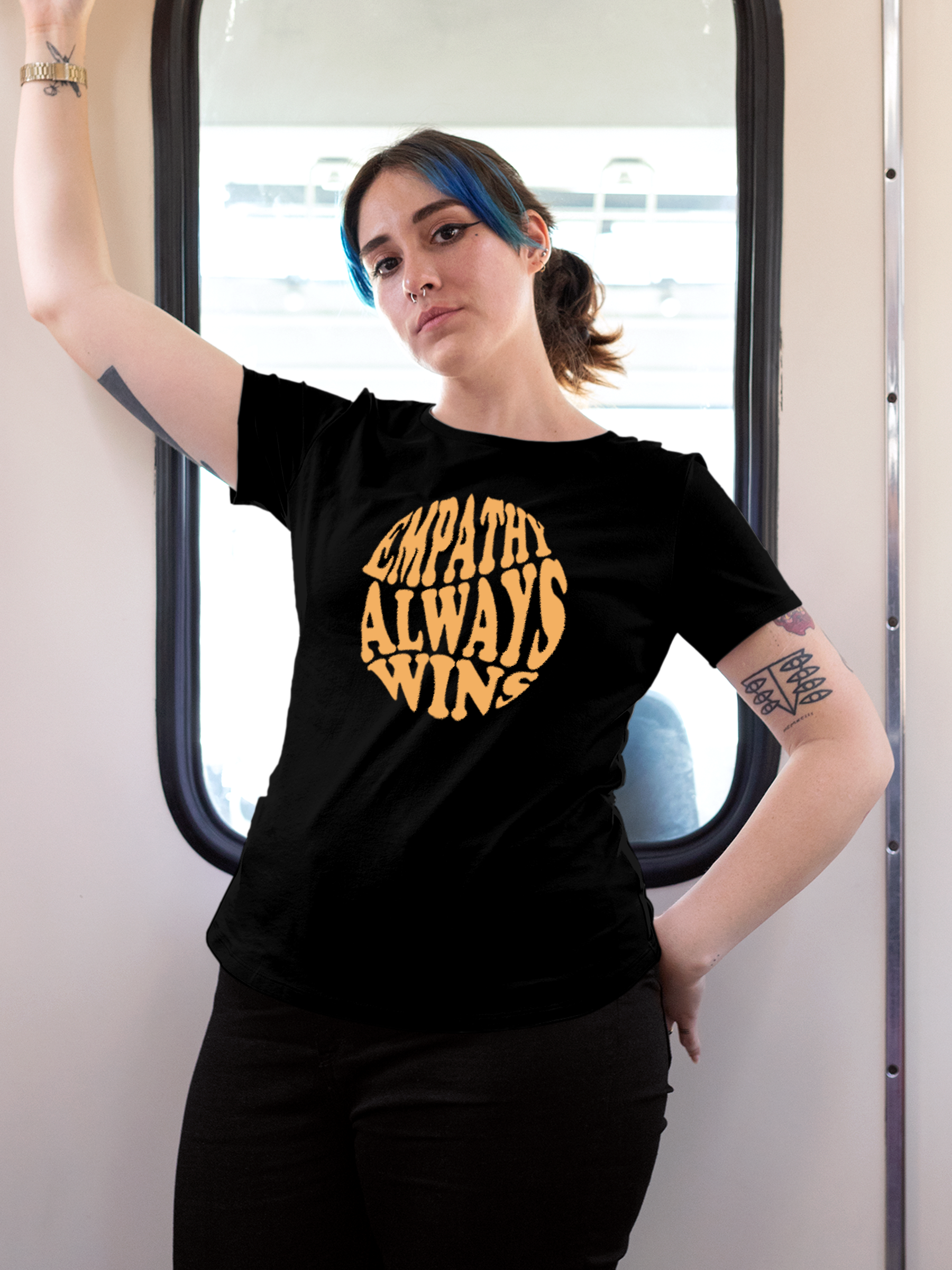Model wearing Women's Black Round Neck T-shirt with 'Empathy Always Wins' design, offering effortless style and premium comfort