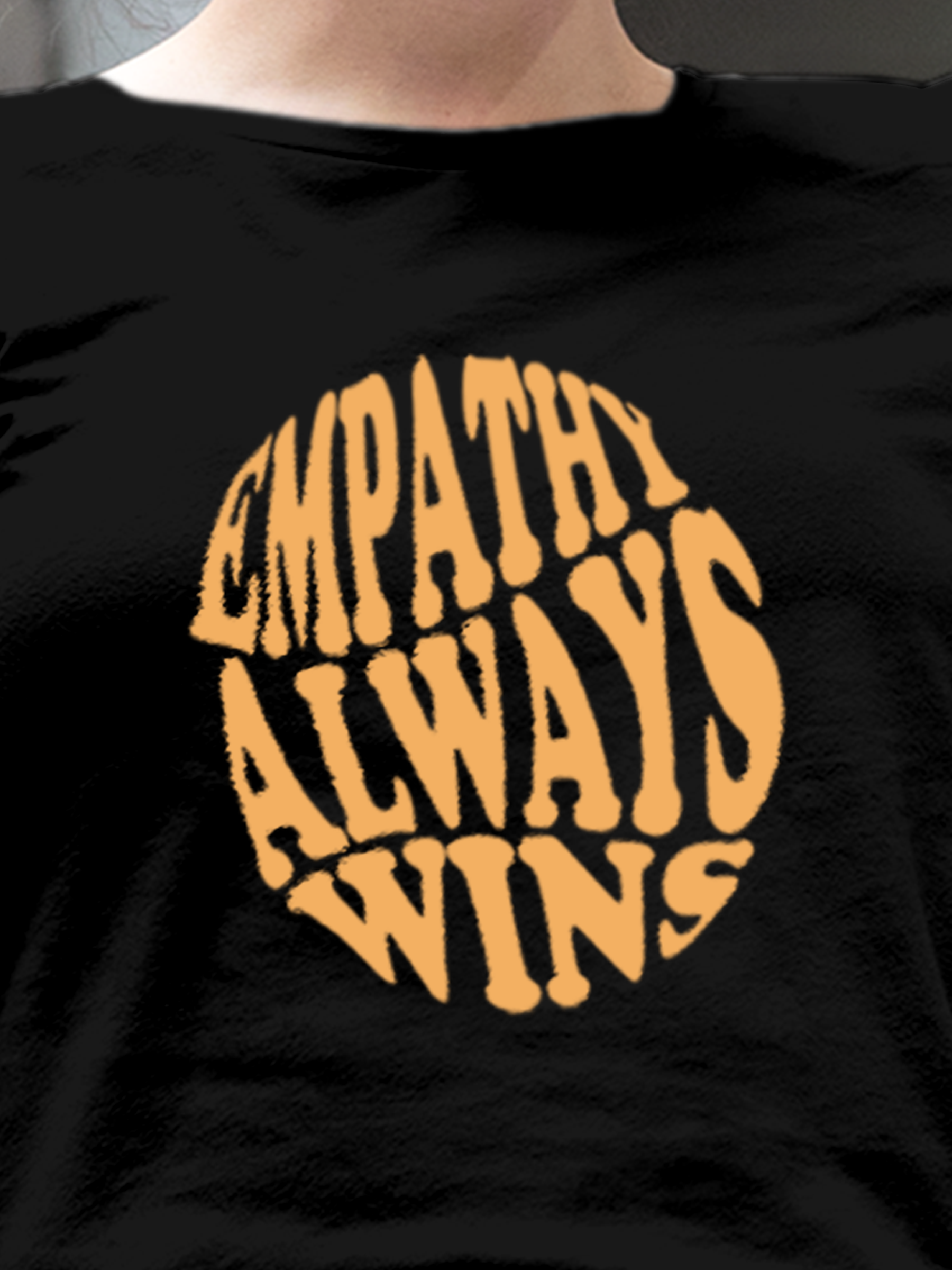 Close up of 'Empathy Always Wins' design on Women's Black Round Neck T-shirt, highlighting intricate details and vibrant print.