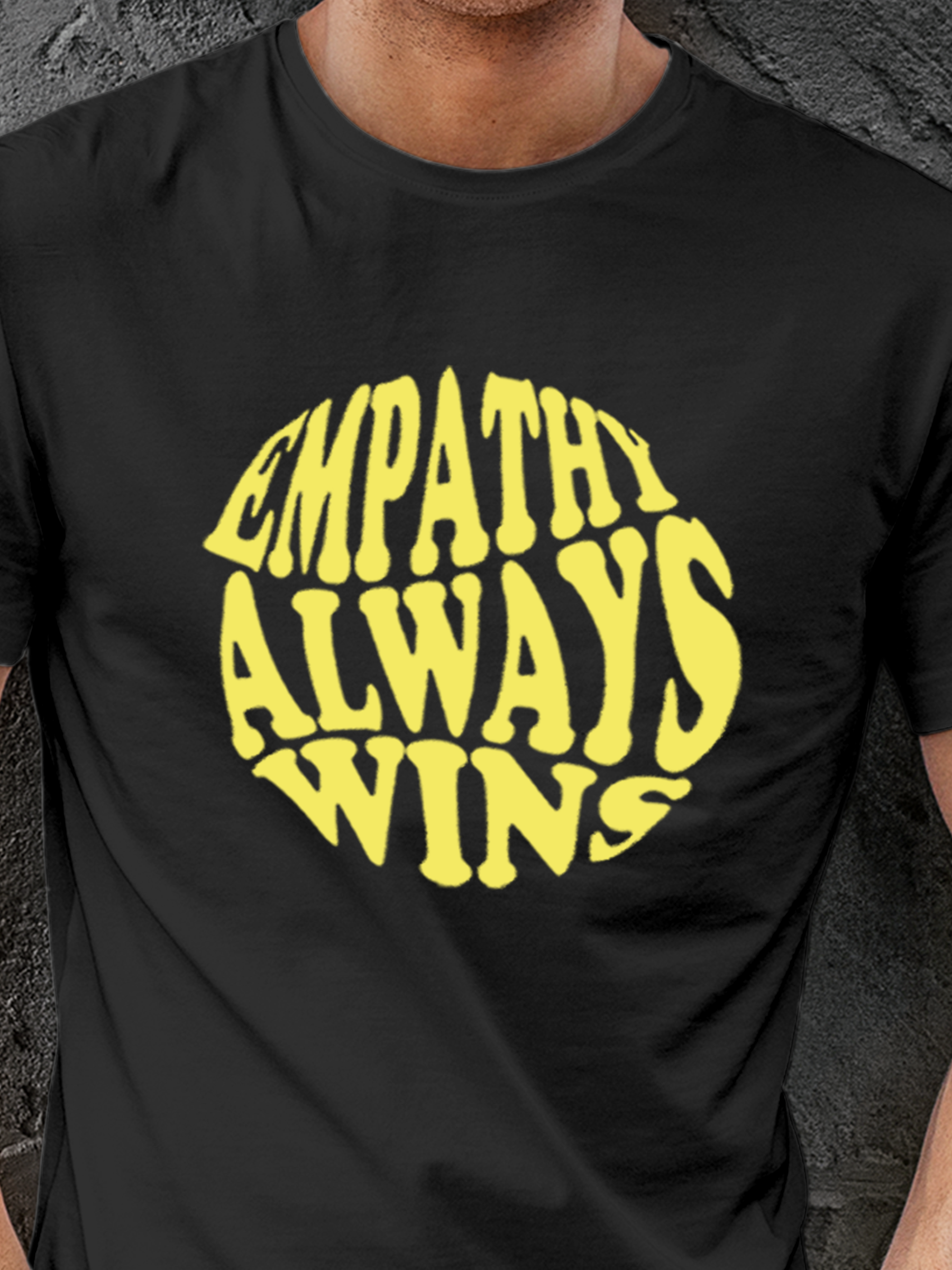 Close up of 'Empathy Always Wins' design on Men's Dark Grey Round Neck T-shirt, highlighting intricate details and vibrant print.
