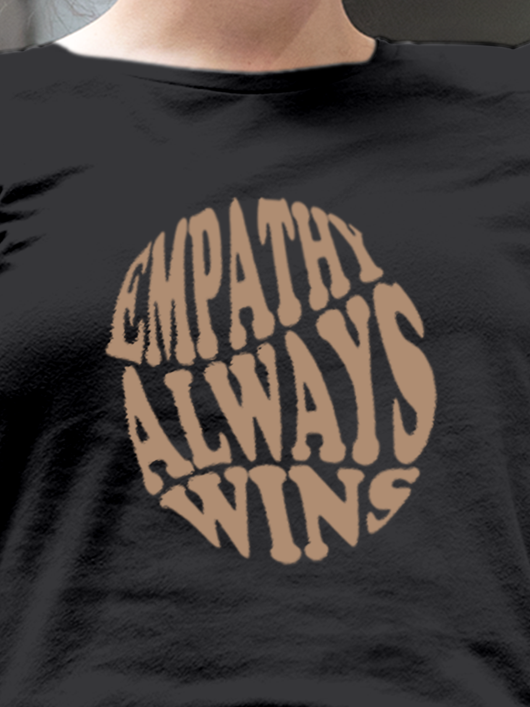 Close up of 'Empathy Always Wins' design on Women's Dark Grey Round Neck T-shirt, highlighting intricate details and vibrant print.