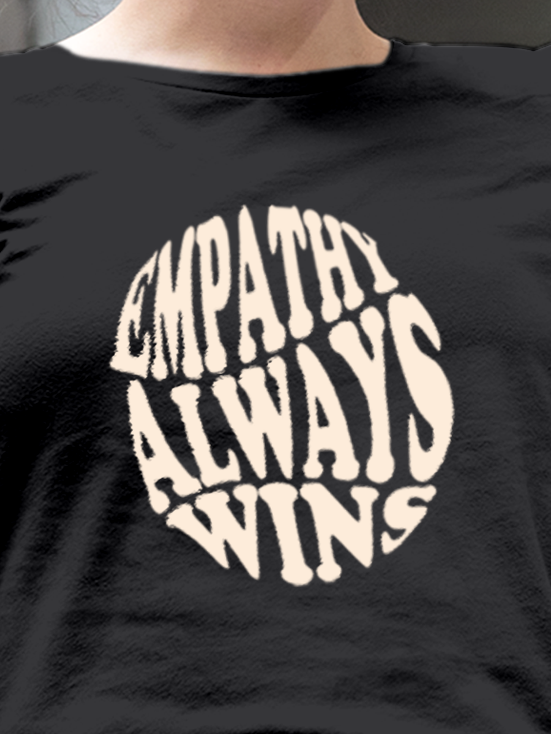 Close up of 'Empathy Always Wins' design on Women's Dark Grey Round Neck T-shirt, highlighting intricate details and vibrant print.
